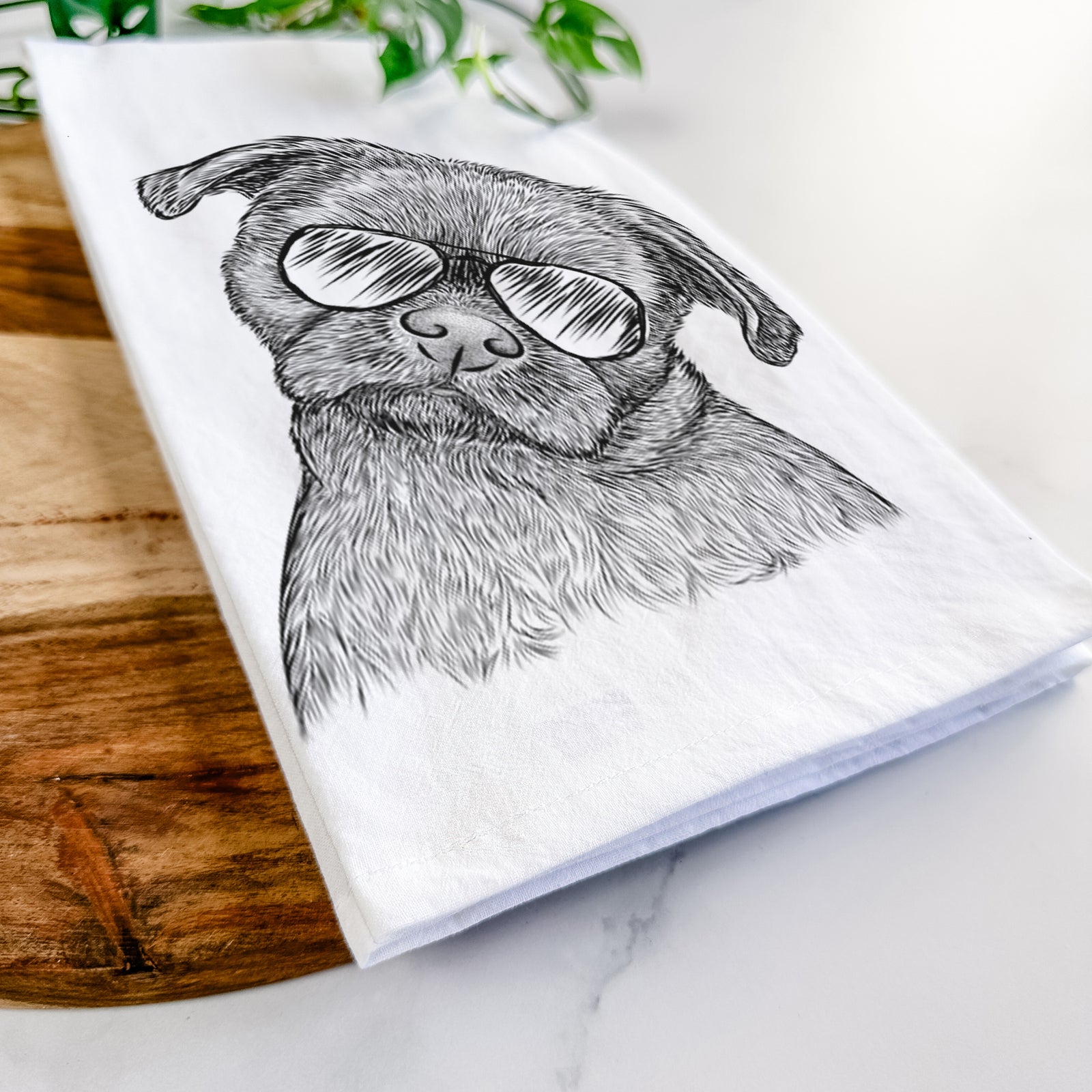 Hand-drawn sketch of Koko the Shih Tzu wearing aviator sunglasses on a tea towel