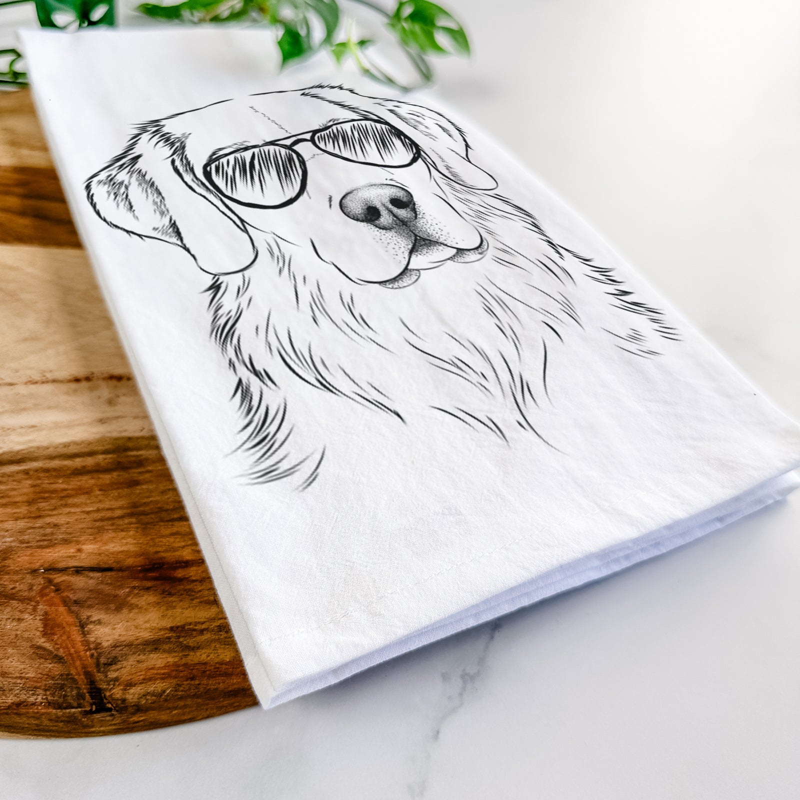 Hand-drawn sketch of Kula the Golden Retriever wearing aviator sunglasses on a tea towel