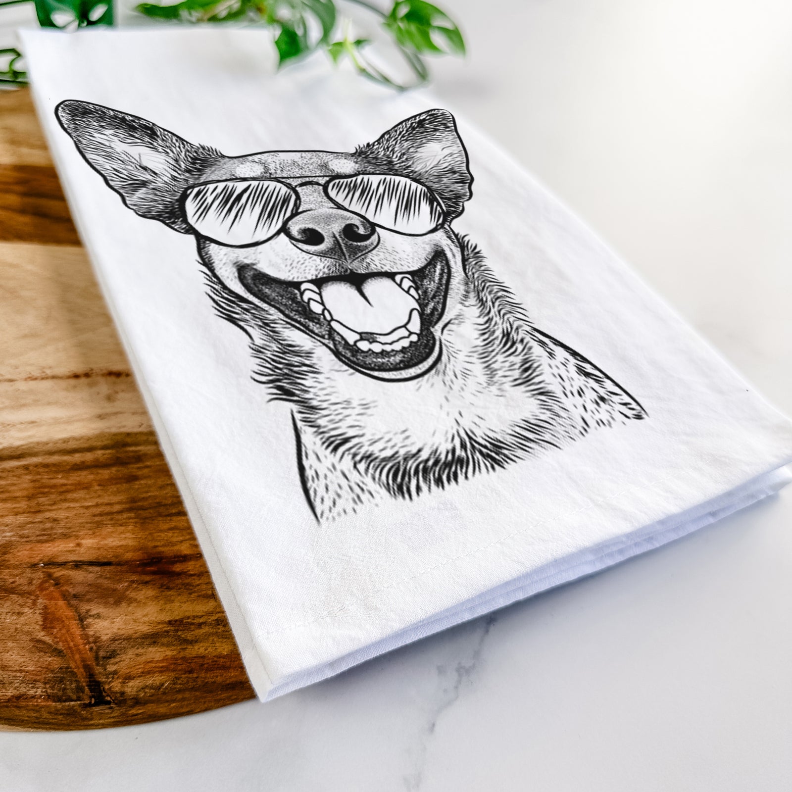 Hand-drawn sketch of Lily the Australian Cattle Dog wearing aviator sunglasses on a tea towel