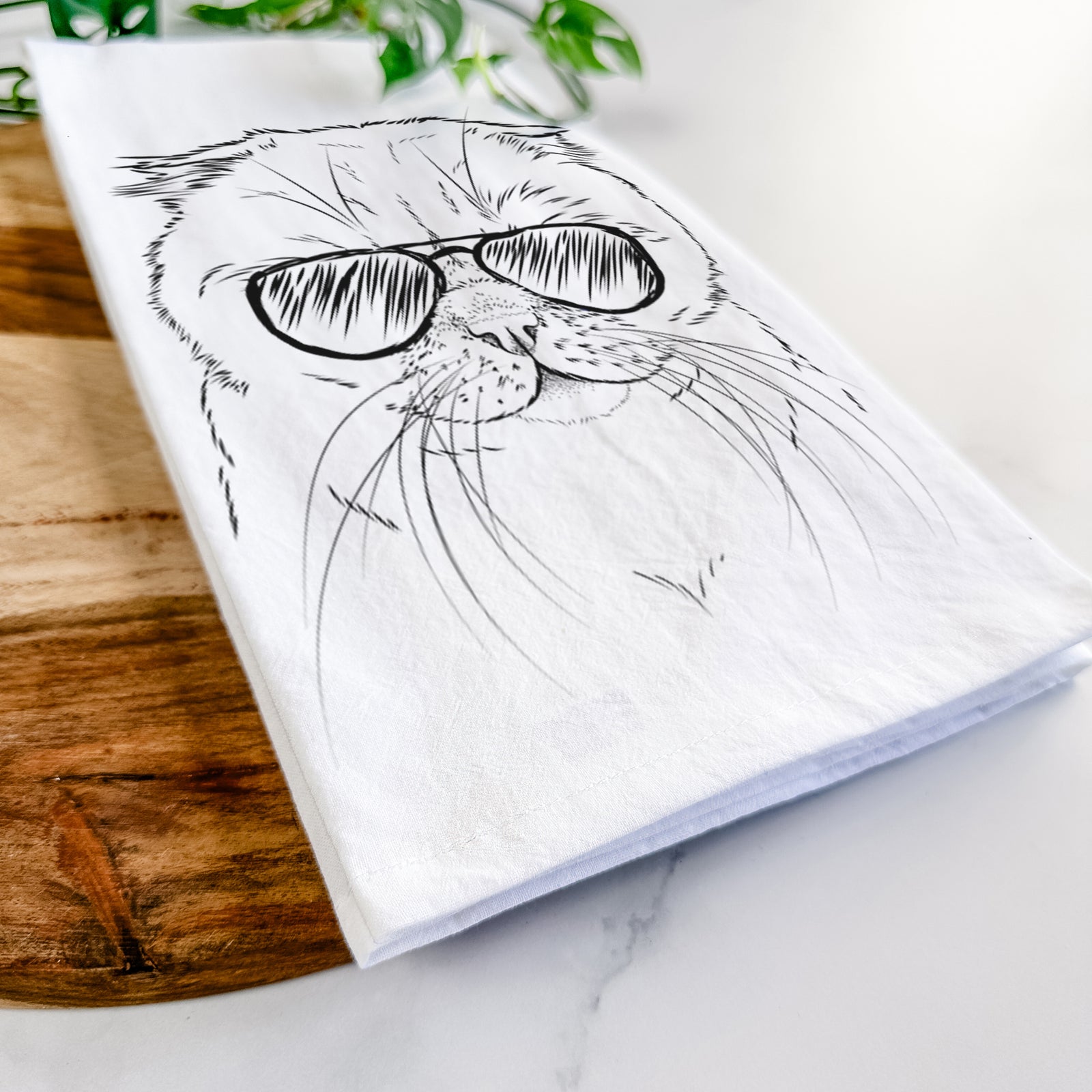 Hand-drawn sketch of Lina the Exotic Fold Cat wearing aviator sunglasses on a tea towel