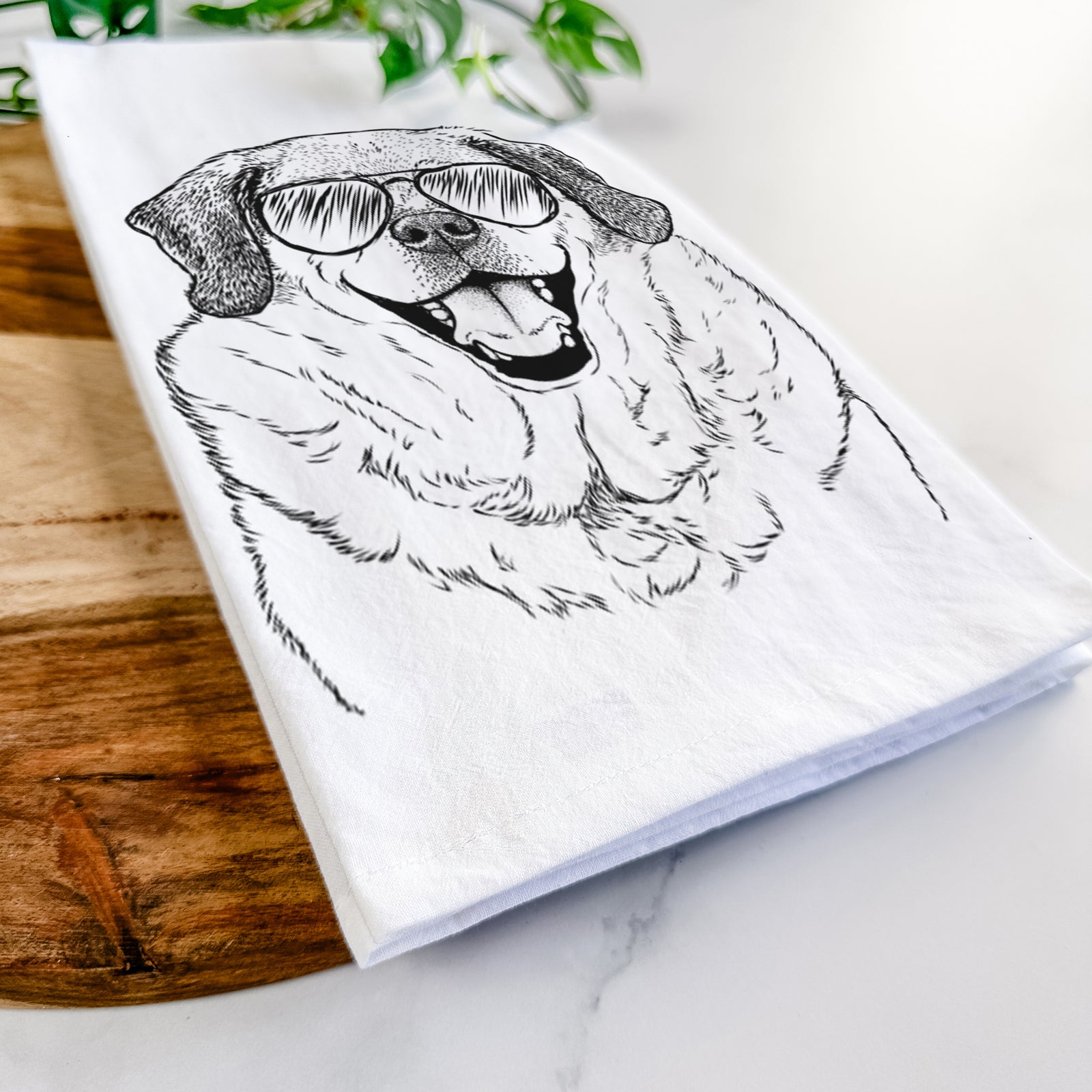 Hand-drawn sketch of Little Man the Puggle wearing aviator sunglasses on a tea towel
