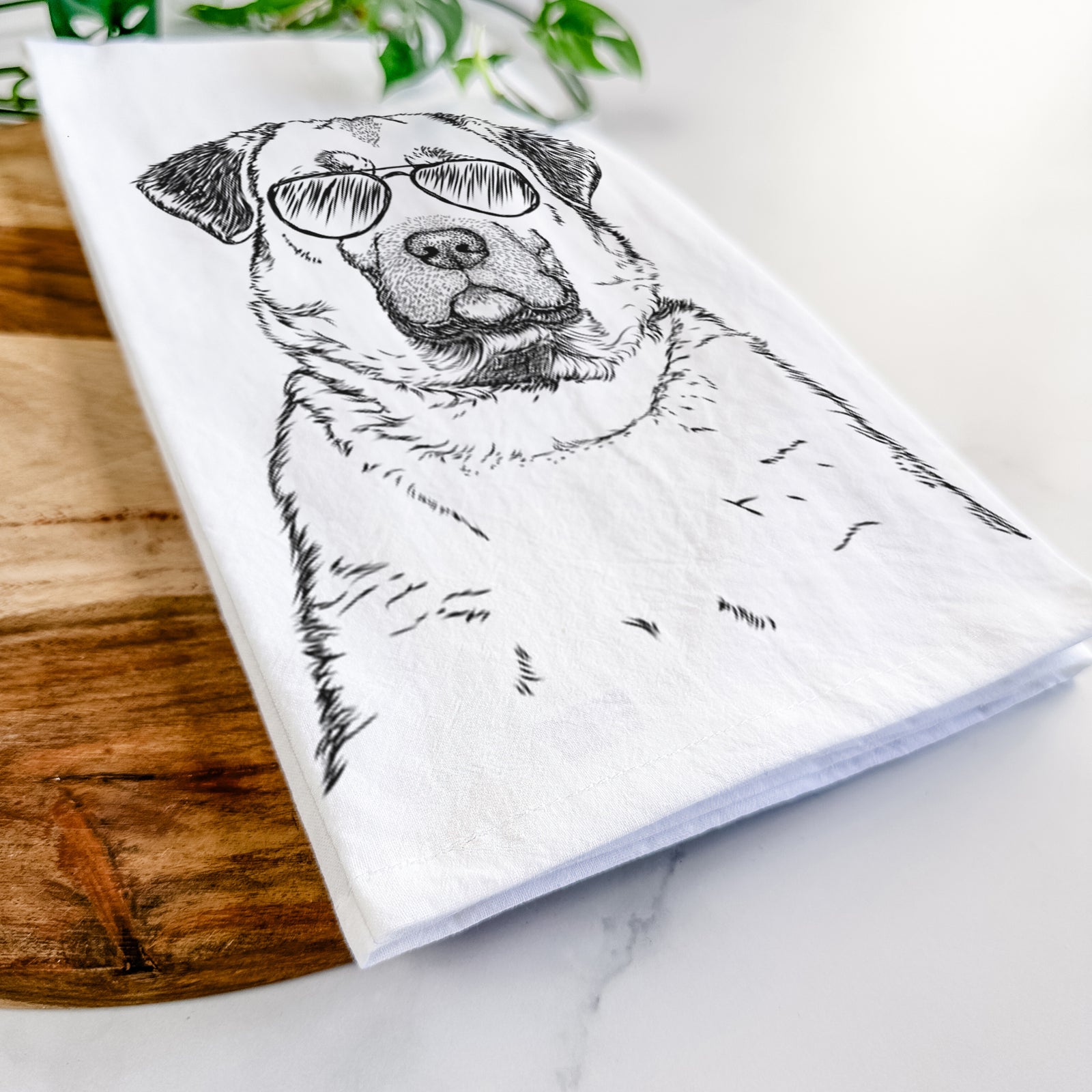 Hand-drawn sketch of Loca the Anatolian Shepherd wearing aviator sunglasses on a tea towel