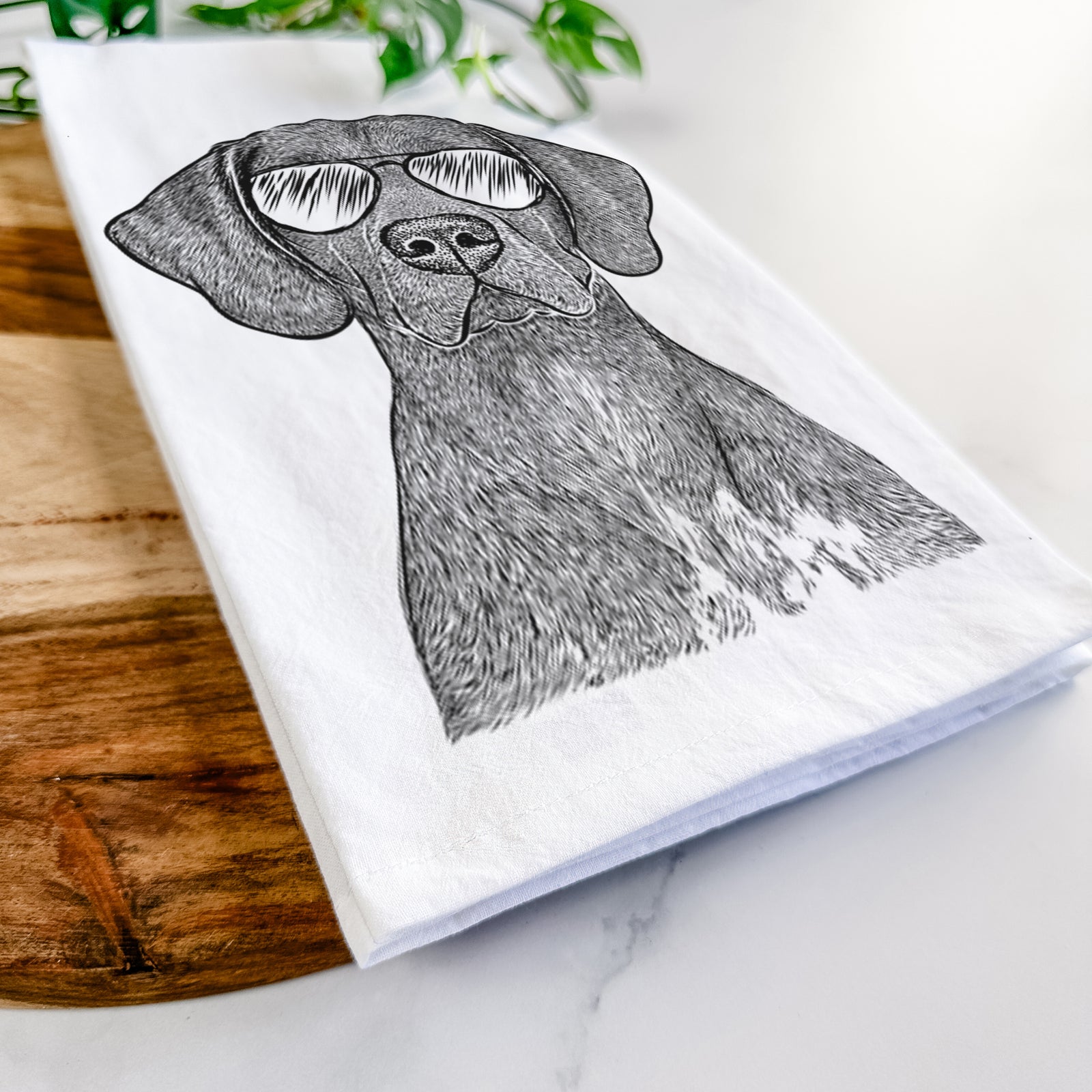 Hand-drawn sketch of Lucifer the German Shorthaired Pointer wearing aviator sunglasses on a tea towel