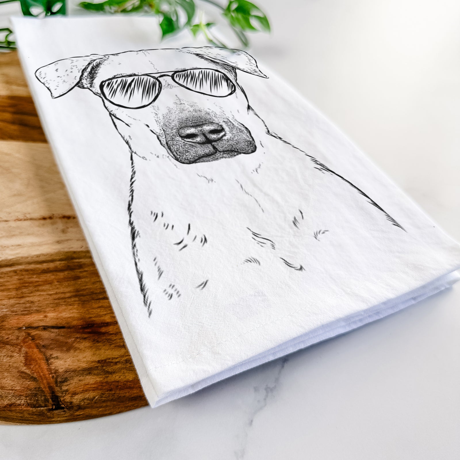Hand-drawn sketch of Luna the Black Mouth Cur wearing aviator sunglasses on a tea towel