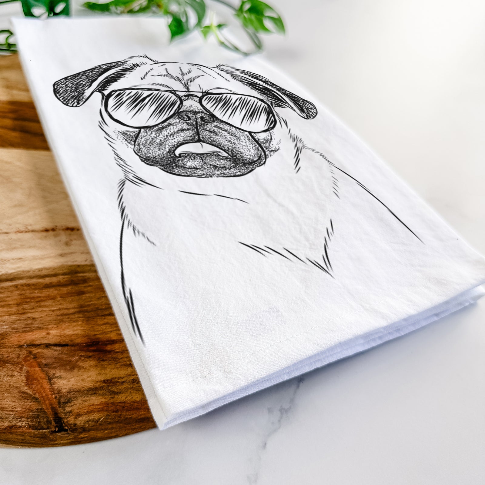 Hand-drawn sketch of Macy the Pug wearing aviator sunglasses on a tea towel