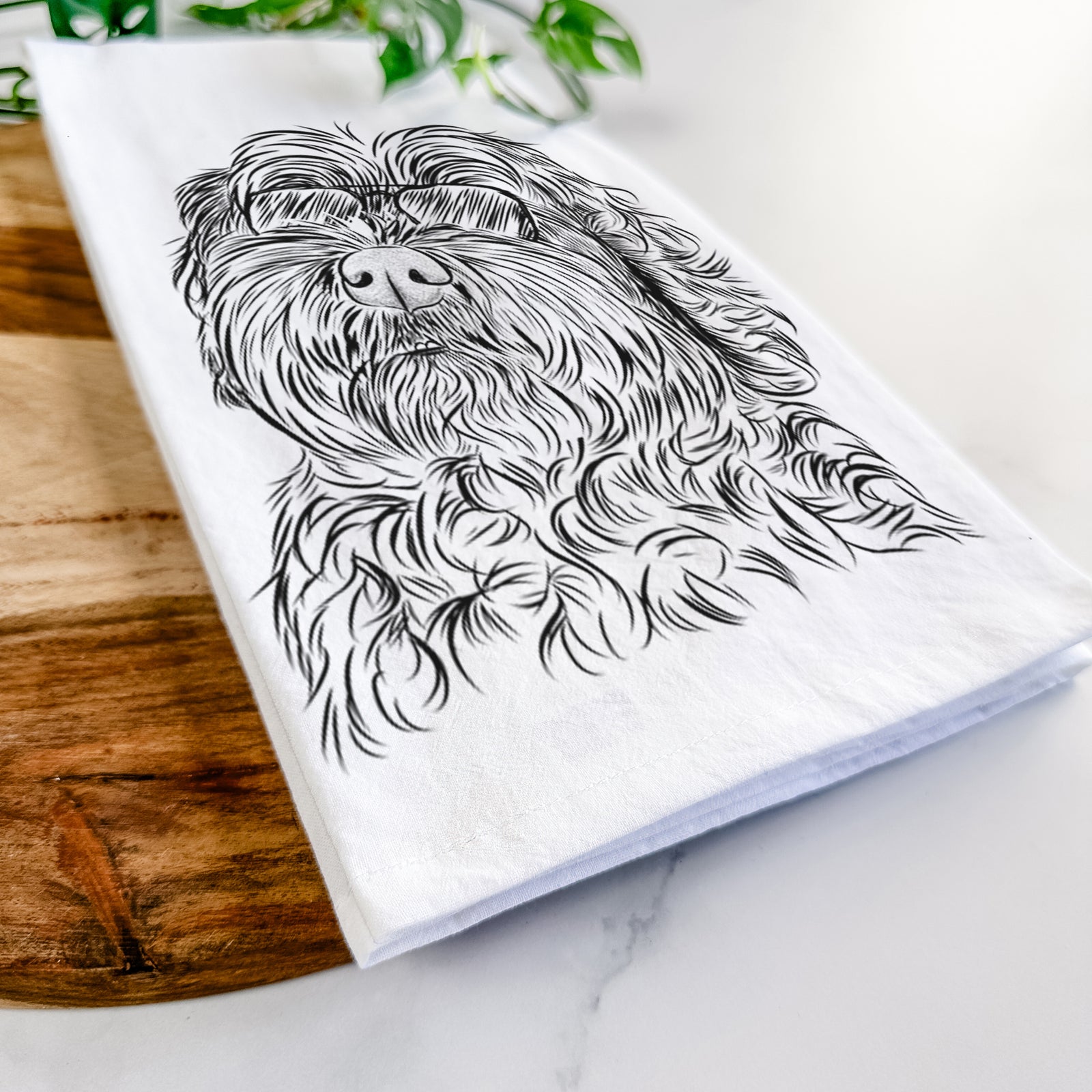 Hand-drawn sketch of Maggie Girl the Cockapoo wearing aviator sunglasses on a tea towel