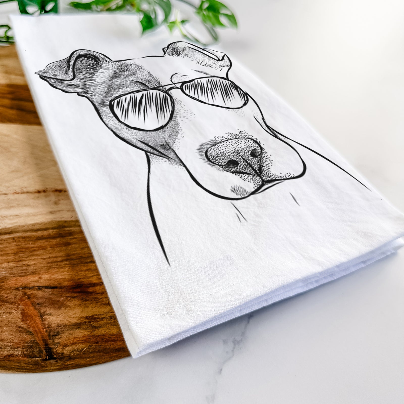 Hand-drawn sketch of Manchi the Pitbull Mix wearing aviator sunglasses on a tea towel