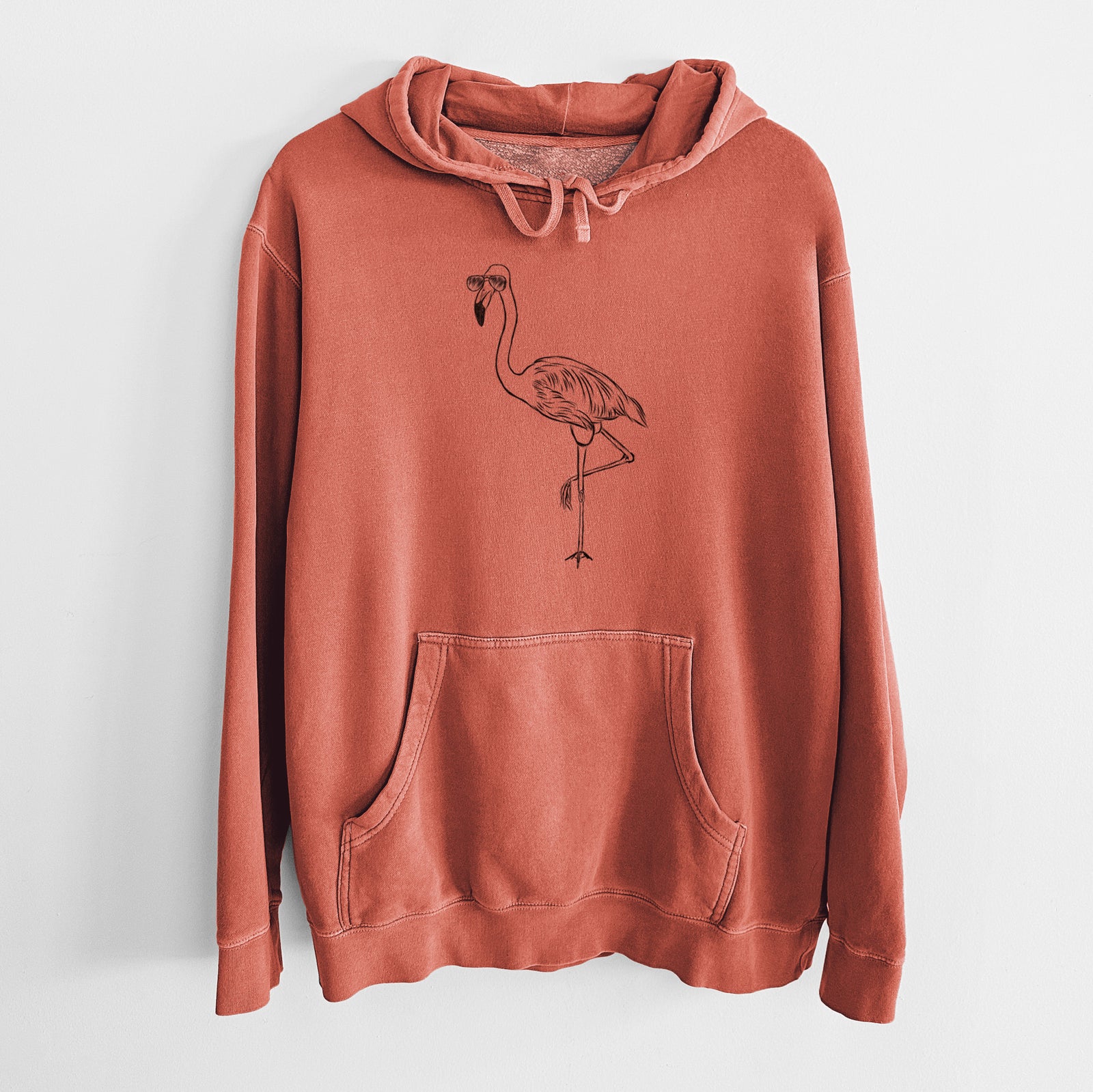 Hand-drawn sketch of Mango the Flamingo wearing aviator sunglasses on an Amber Unisex pigment dyed hoodie