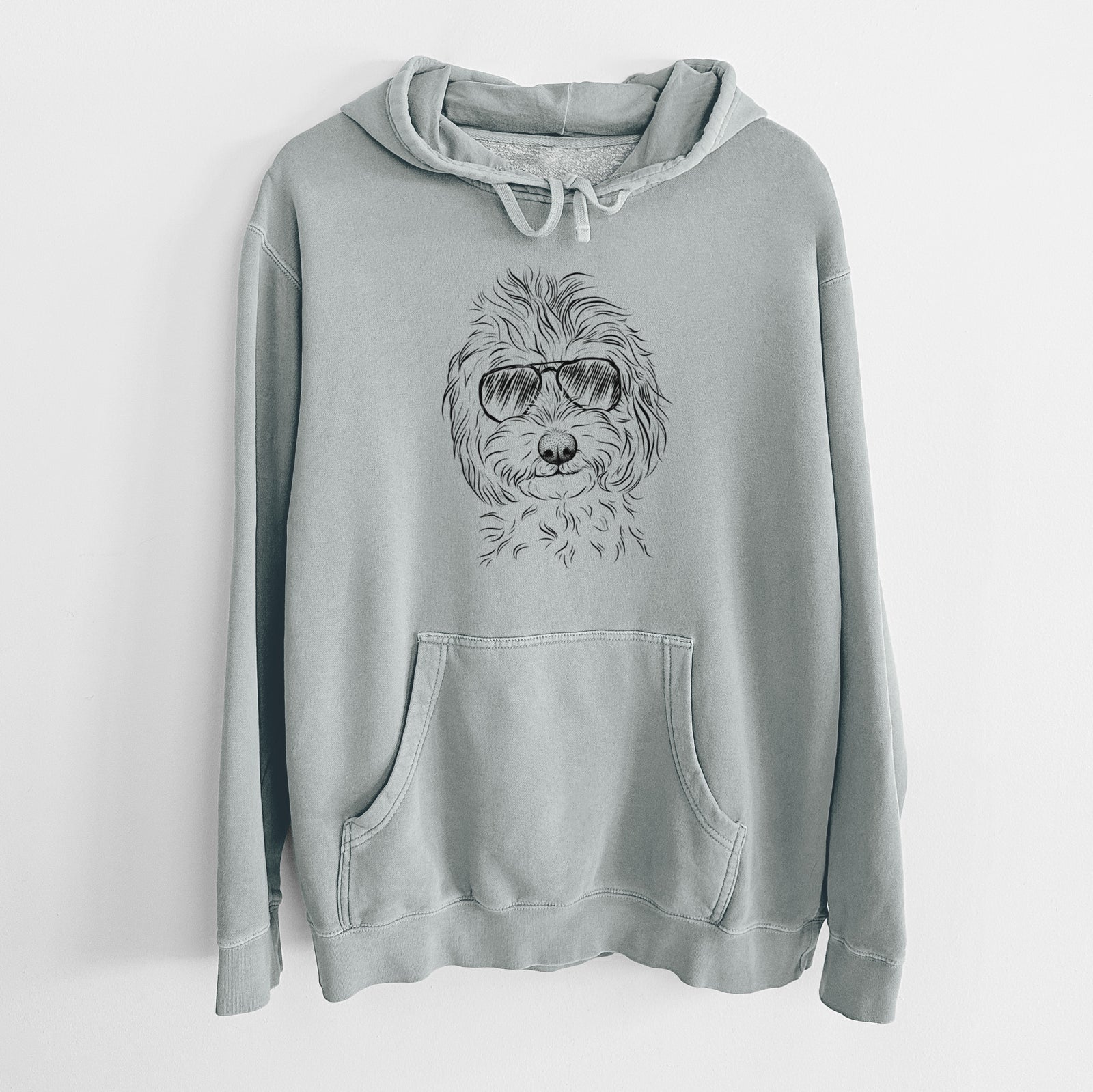 Hand-drawn sketch of Mason the Cavapoo wearing aviator sunglasses on a Sage Unisex pigment dyed hoodie