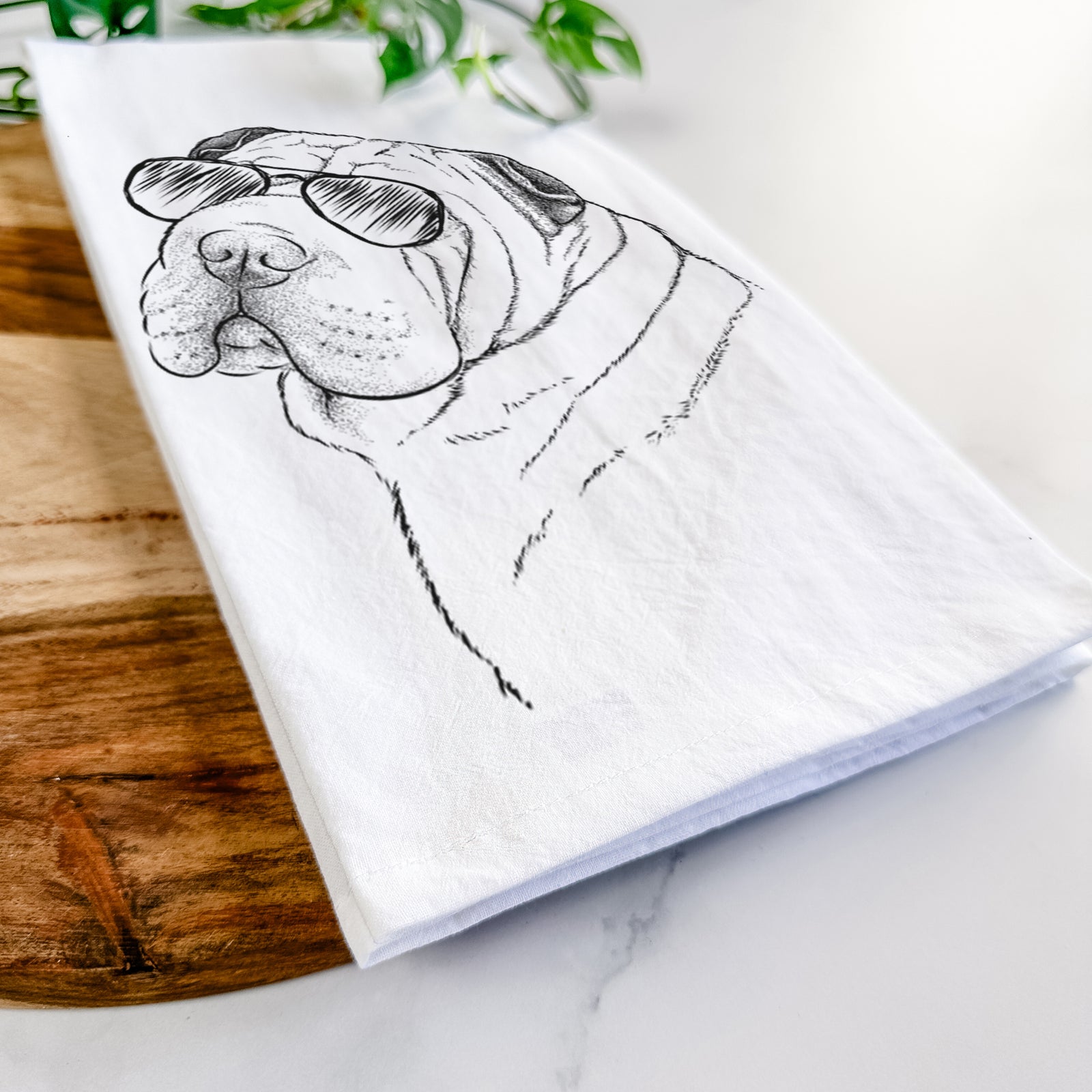 Hand-drawn sketch of Maximus the Shar Pei wearing aviator sunglasses on a tea towel