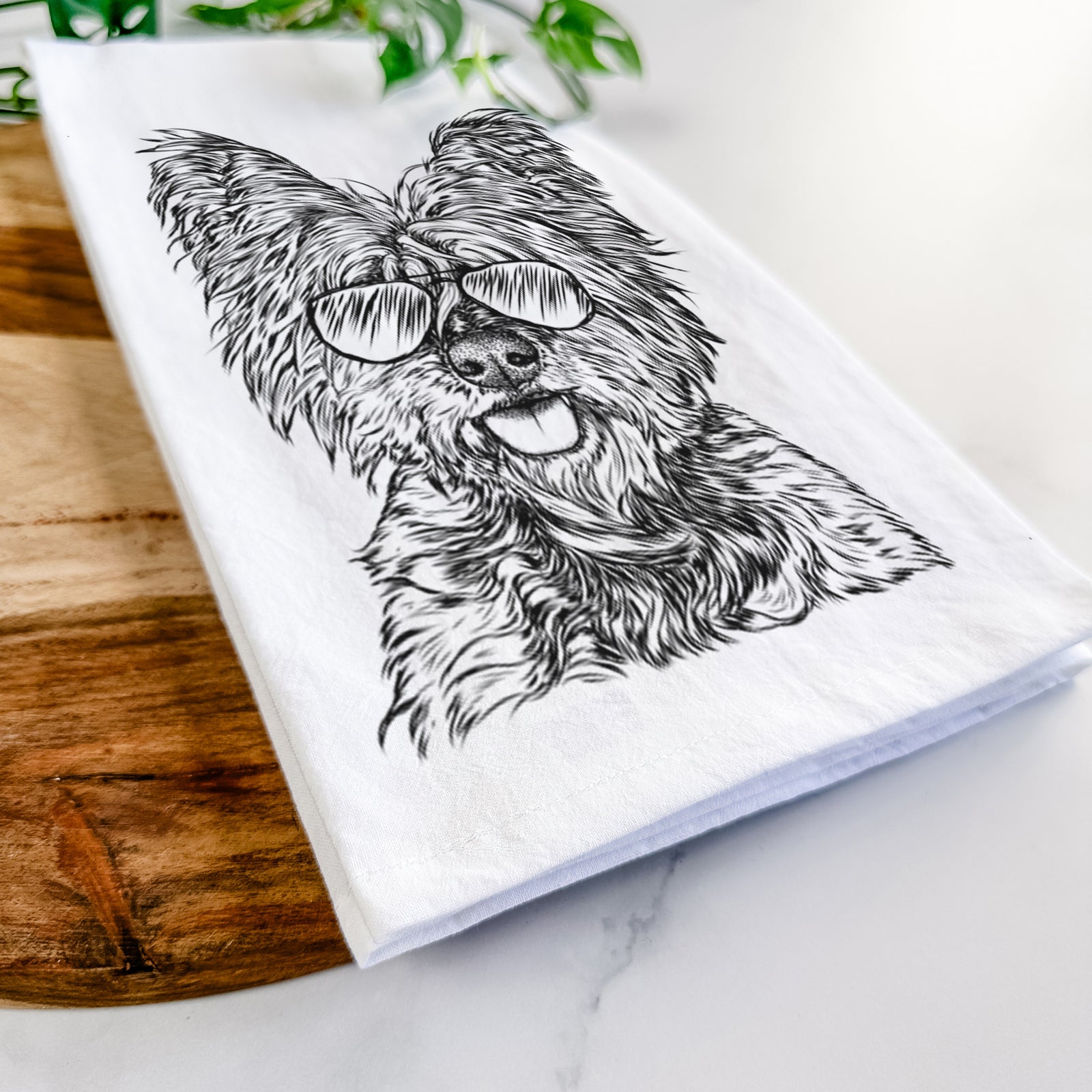 Hand-drawn sketch of McDuff the Cairn Terrier wearing aviator sunglasses on a tea towel