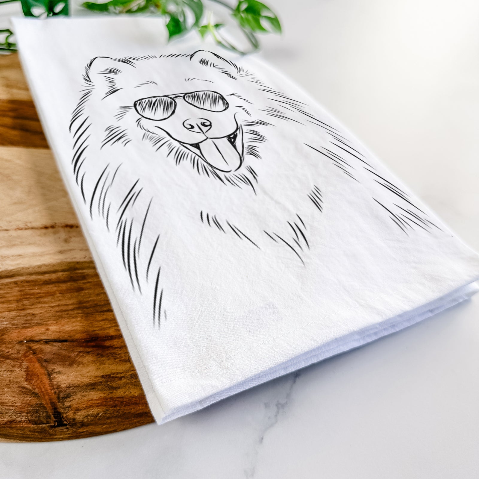 Hand-drawn sketch of Mikko the Samoyed wearing aviator sunglasses on a tea towel