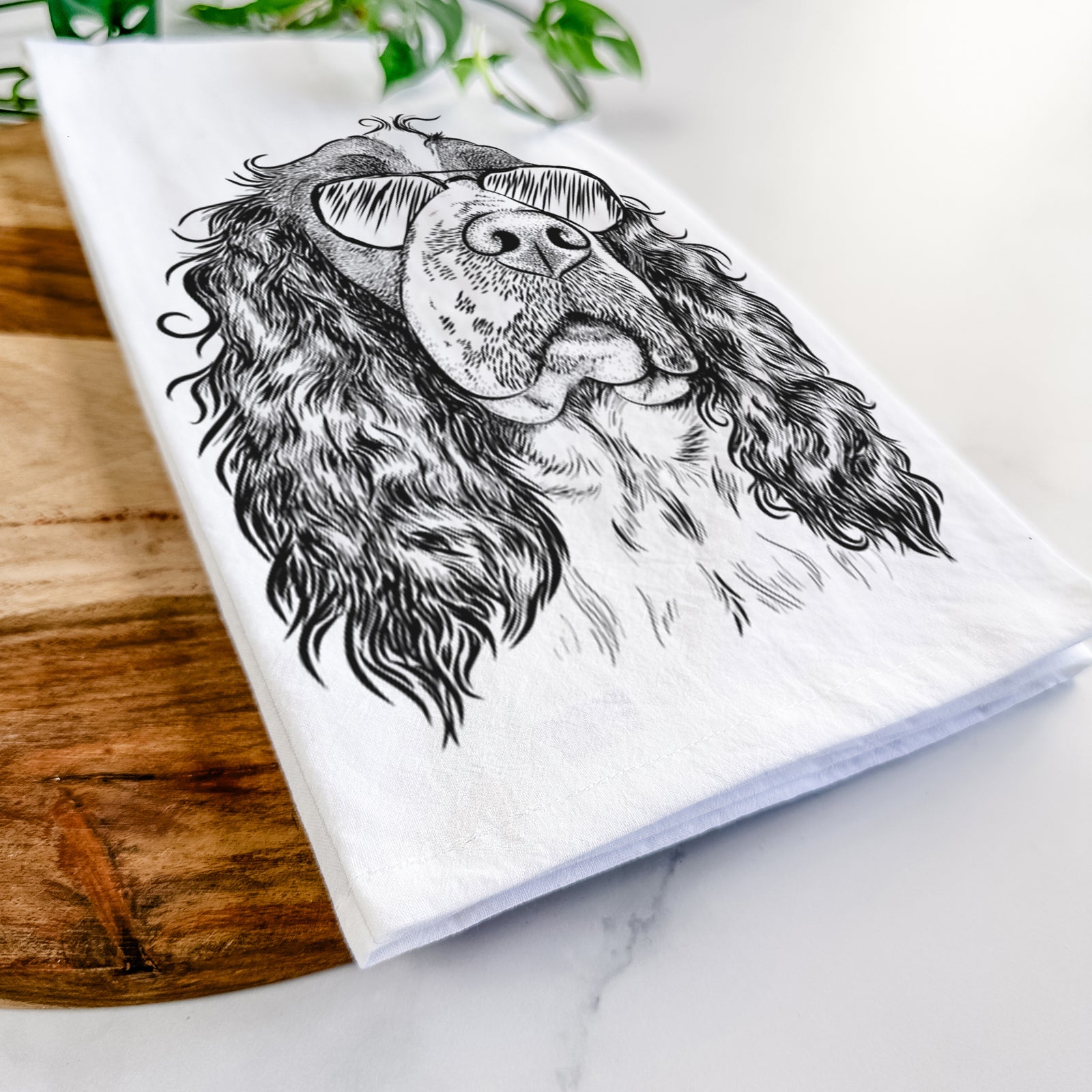 Hand-drawn sketch of Millie Mae the English Springer Spaniel wearing aviator sunglasses on a tea towel