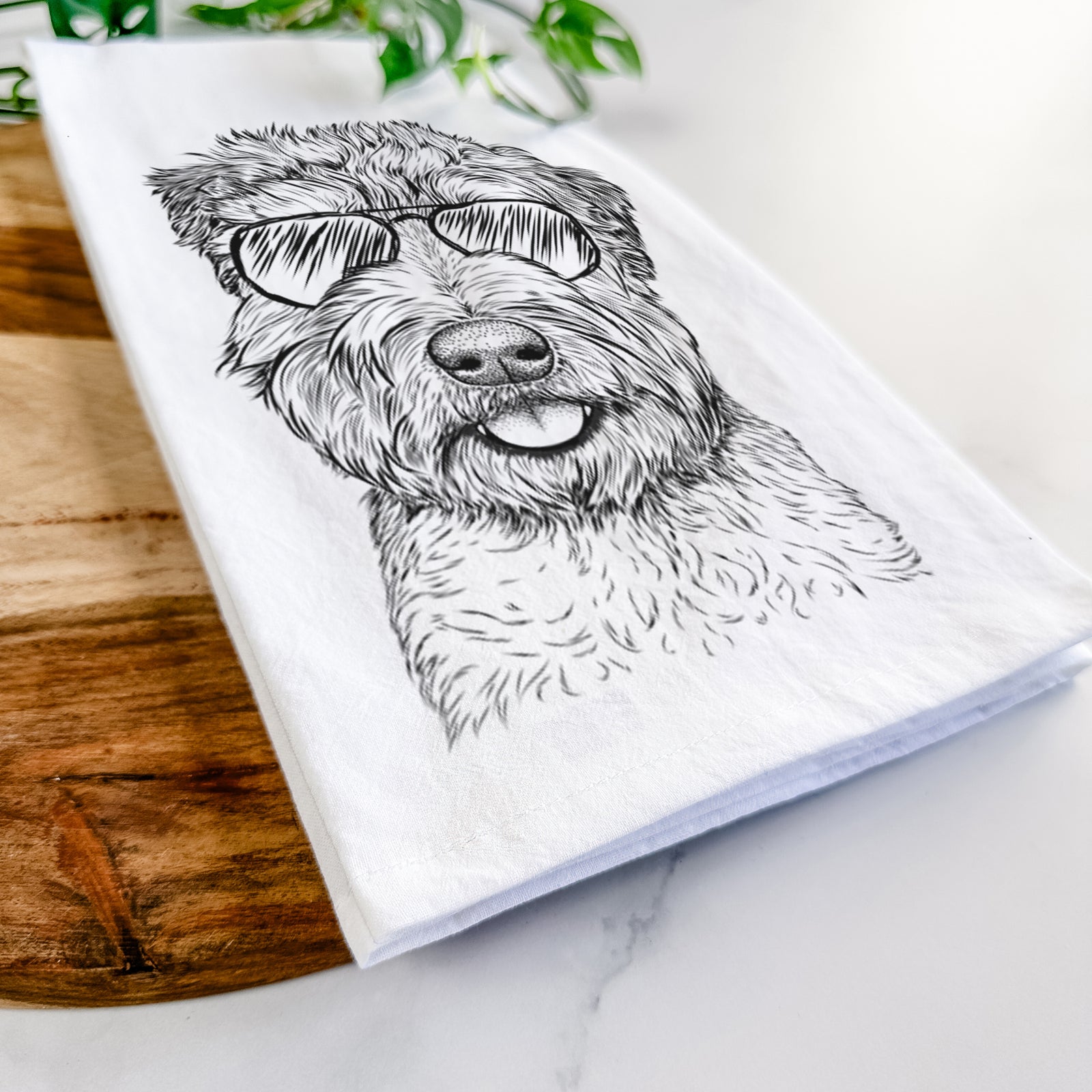 Hand-drawn sketch of Milton the Soft Coated Wheaten Terrier wearing aviator sunglasses on a tea towel