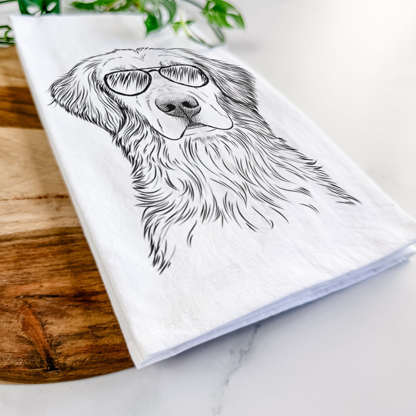 Hand-drawn sketch of Moose the Field Golden Retriever wearing aviator sunglasses on a tea towel