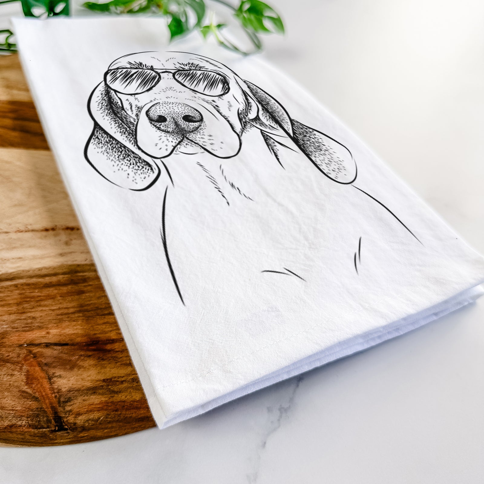Hand-drawn sketch of Norman the Plott Hound wearing aviator sunglasses on a tea towel