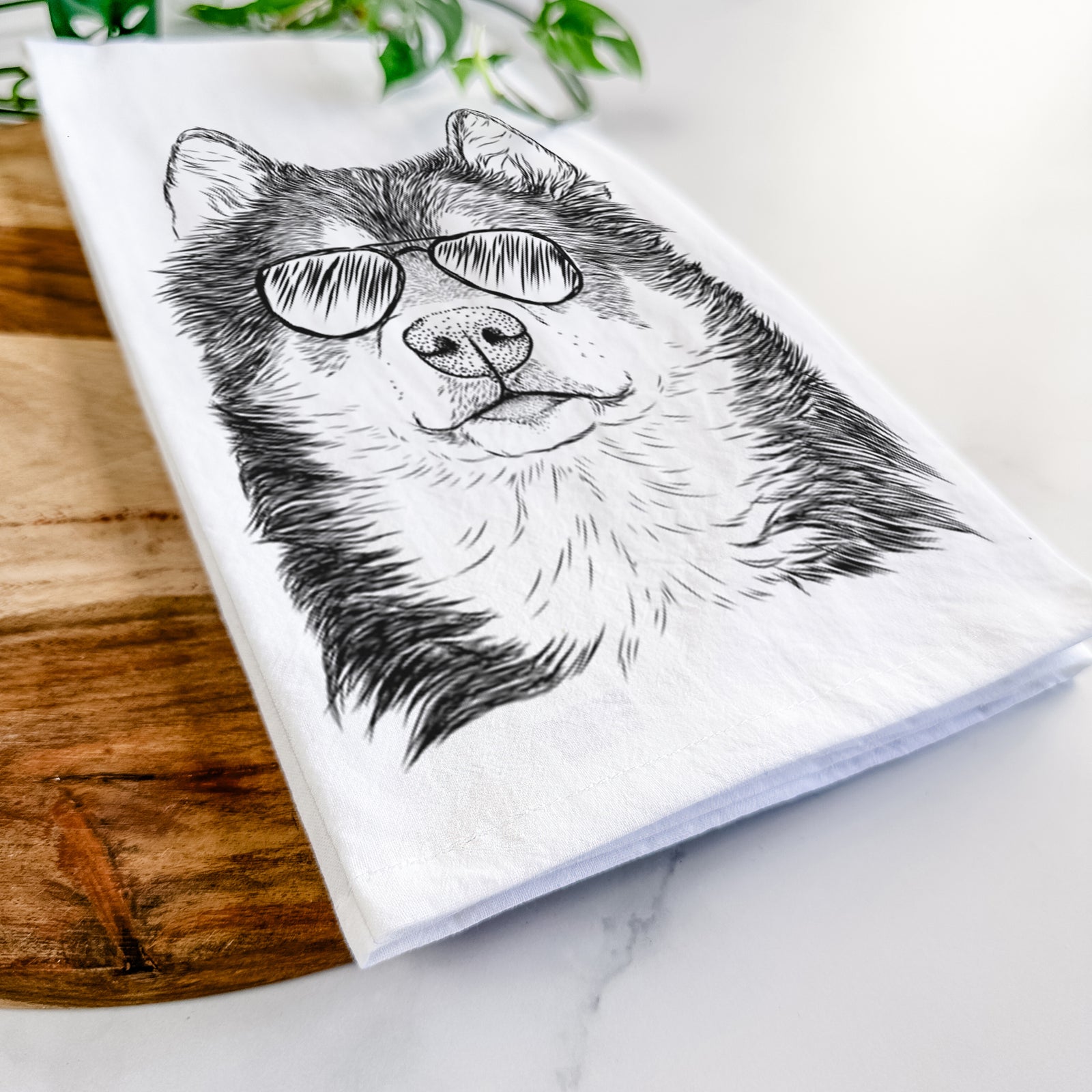 Hand-drawn sketch of Oskar the Canadian Eskimo Dog wearing aviator sunglasses on a tea towel