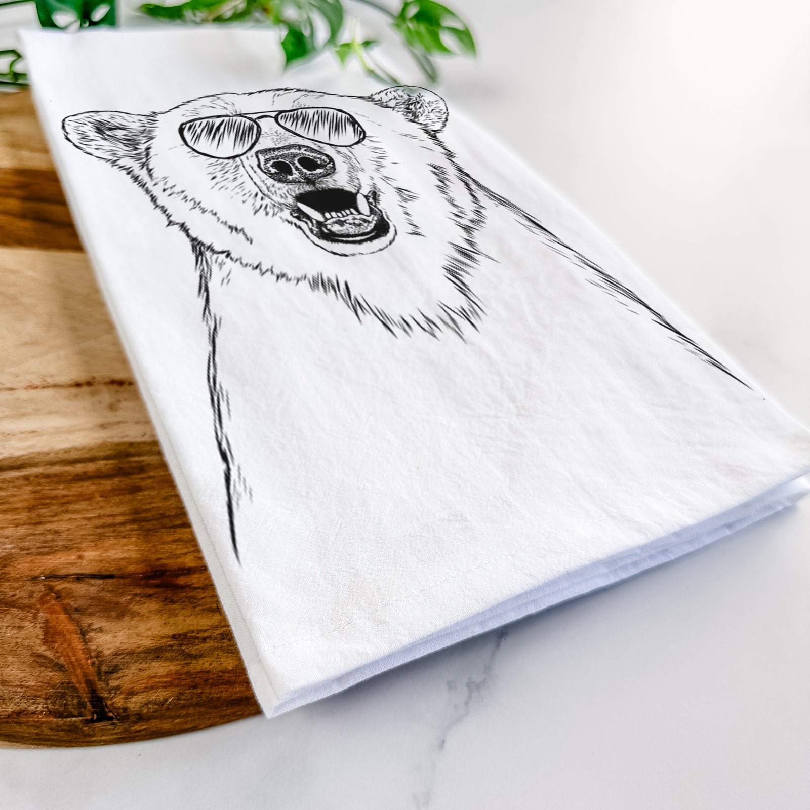 Hand-drawn sketch of Oslo the Polar Bear wearing aviator sunglasses on a tea towel