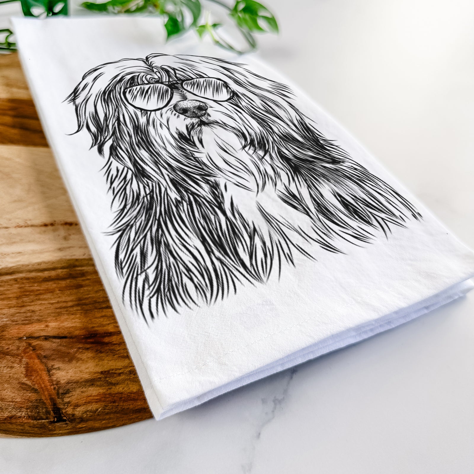 Hand-drawn sketch of Otto the Polish Lowland Sheepdog wearing aviator sunglasses on a tea towel