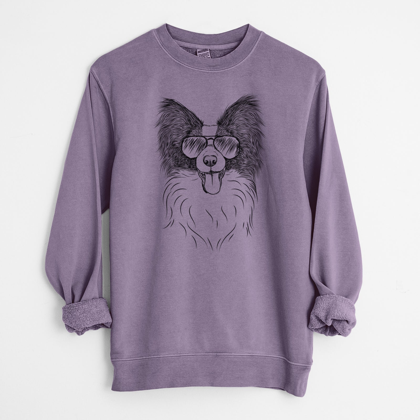Hand-drawn sketch of Patrick the Papillon wearing aviator sunglasses on a Plum Unisex pigment dyed crew sweatshirt