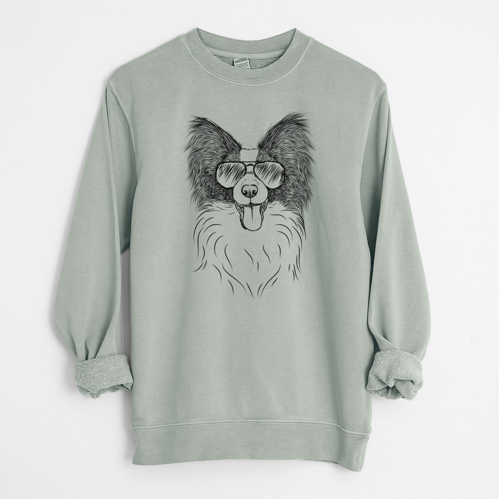 Hand-drawn sketch of Patrick the Papillon wearing aviator sunglasses on a Sage Unisex pigment dyed crew sweatshirt