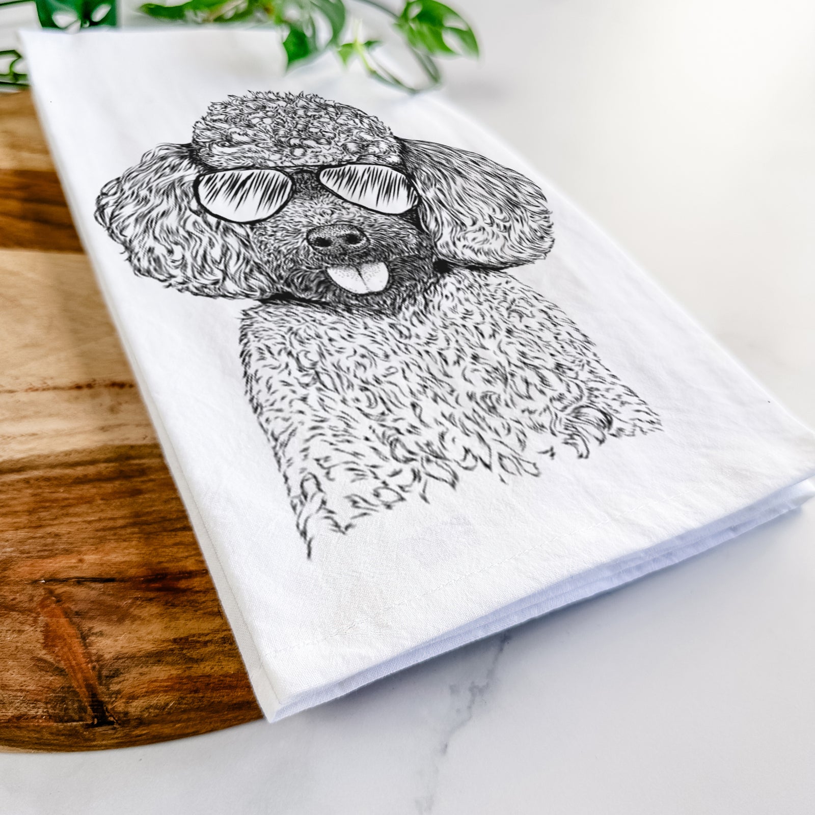 Hand-drawn sketch of George the Toy Poodle wearing aviator sunglasses on a tea towel