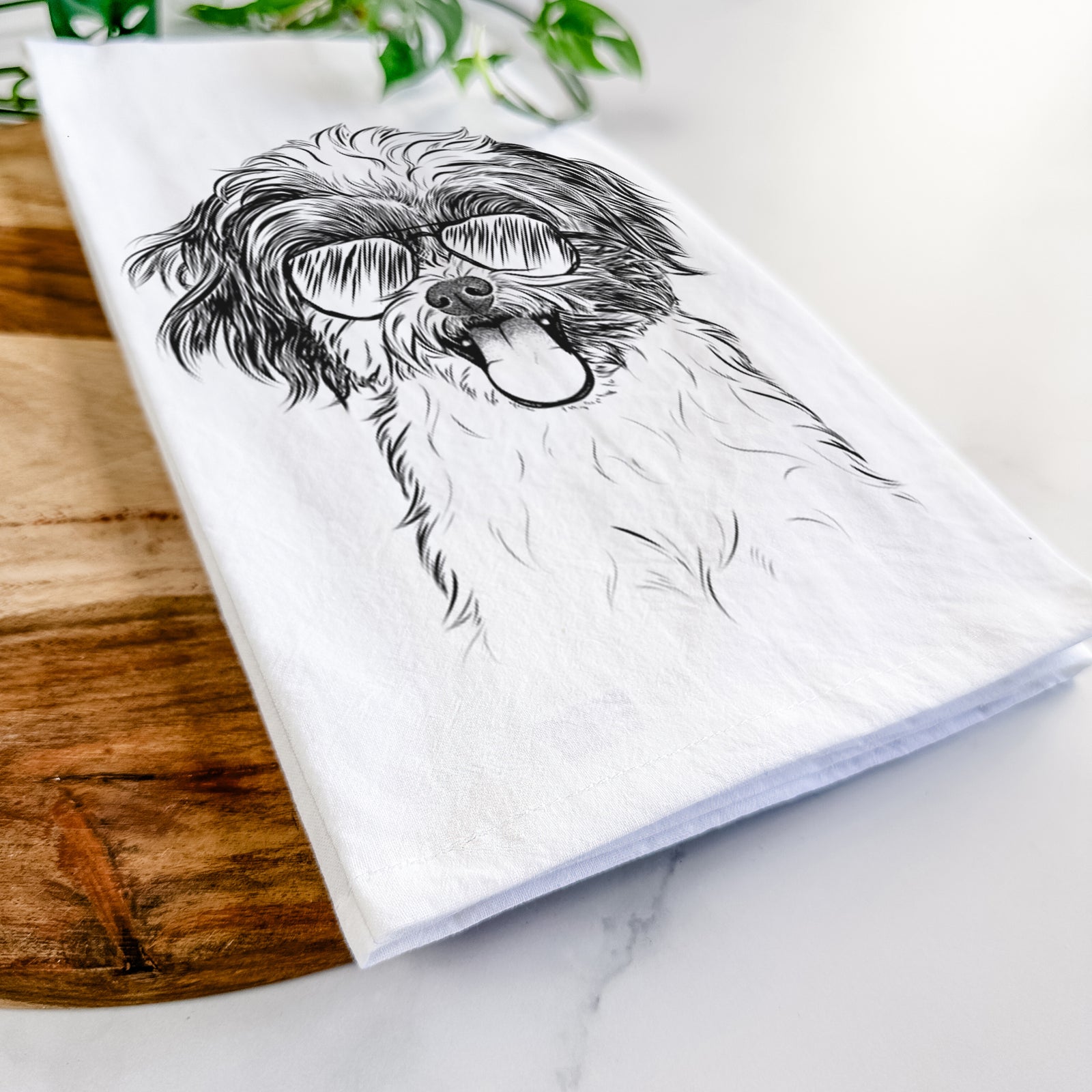 Hand-drawn sketch of Pepper the Shihpoo wearing aviator sunglasses on a tea towel