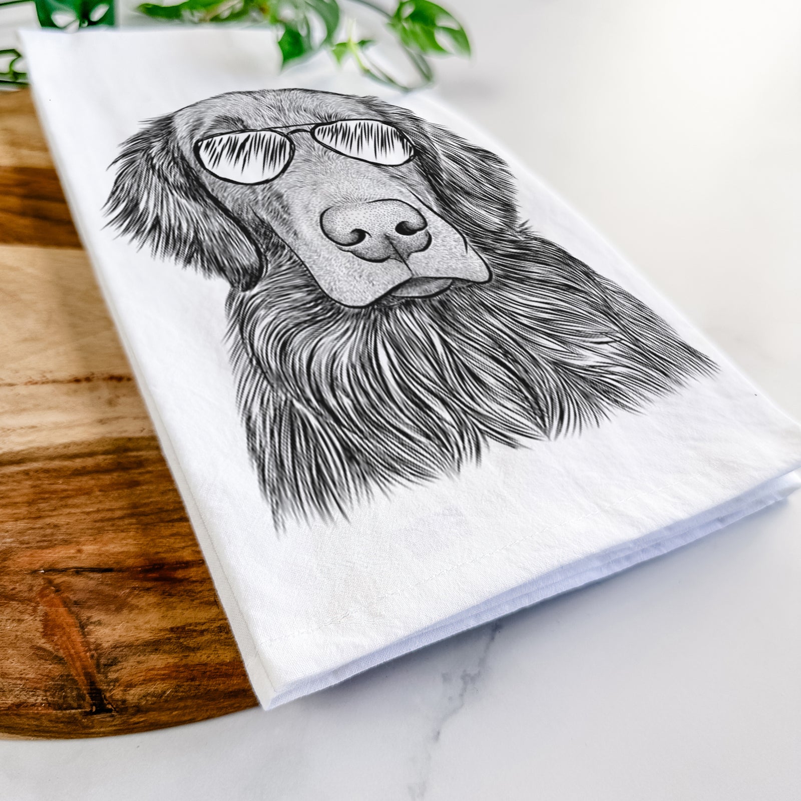 Hand-drawn sketch of Pippin the Flat Coated Retriever wearing aviator sunglasses on a tea towel