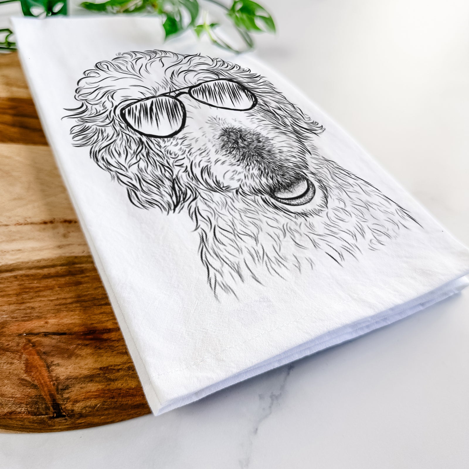 Hand-drawn sketch of Preston the Labradoodle wearing aviator sunglasses on a tea towel