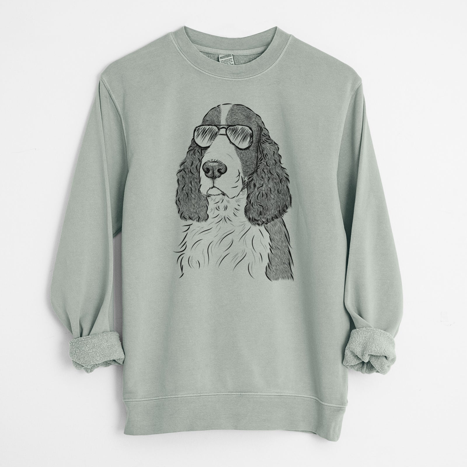 Hand-drawn sketch of Quincy the English Springer Spaniel wearing aviator sunglasses on a Sage Unisex pigment dyed crew sweatshirt