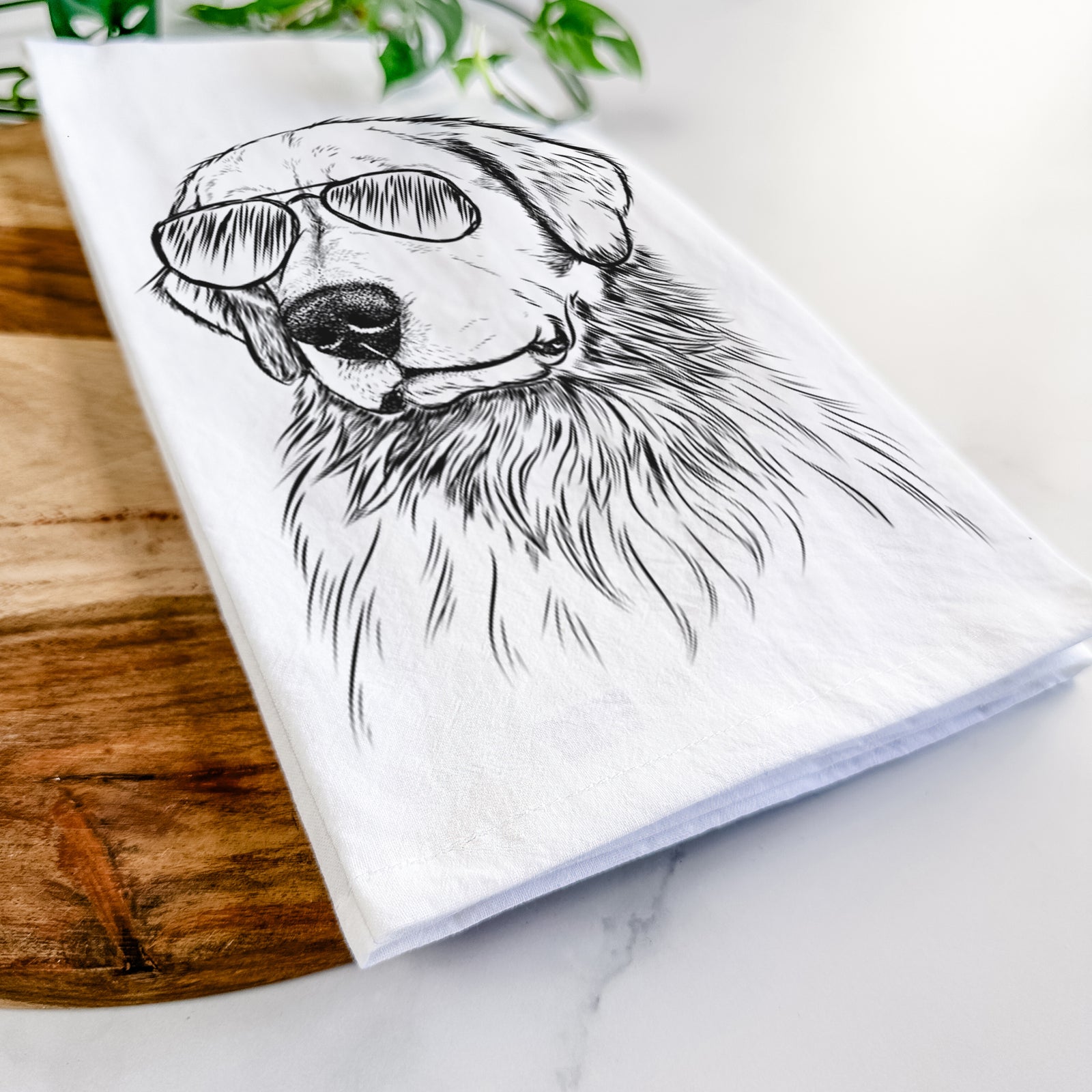 Hand-drawn sketch of Quinn the Golden Retriever wearing aviator sunglasses on a tea towel