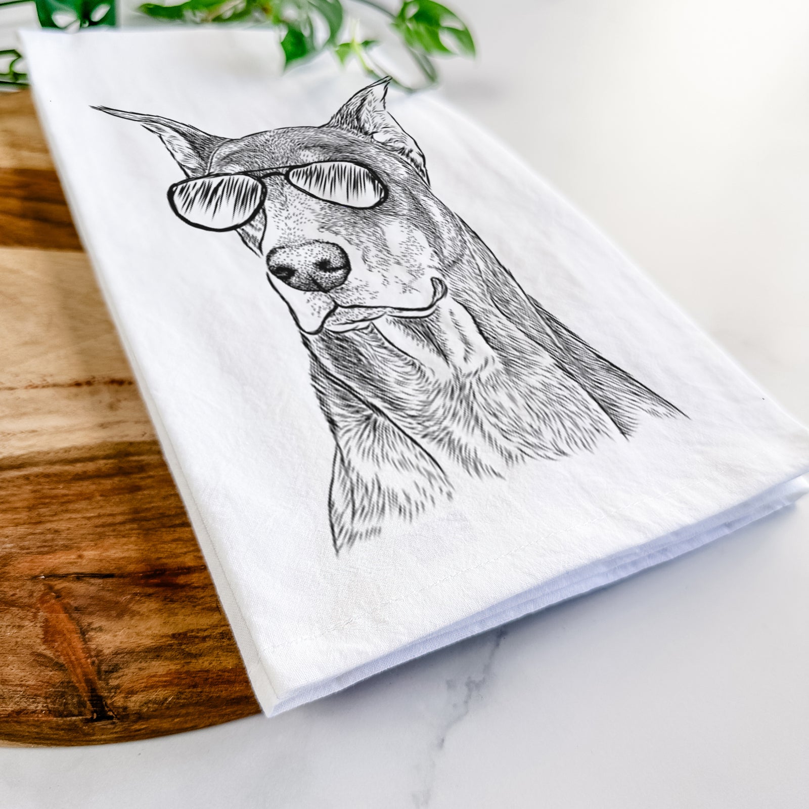 Hand-drawn sketch of RJ the Doberman Pinscher wearing aviator sunglasses on a tea towel