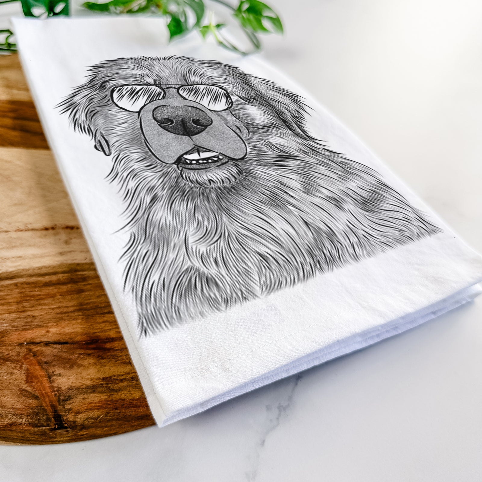 Hand-drawn sketch of Ralph the Leonberger wearing aviator sunglasses on a tea towel