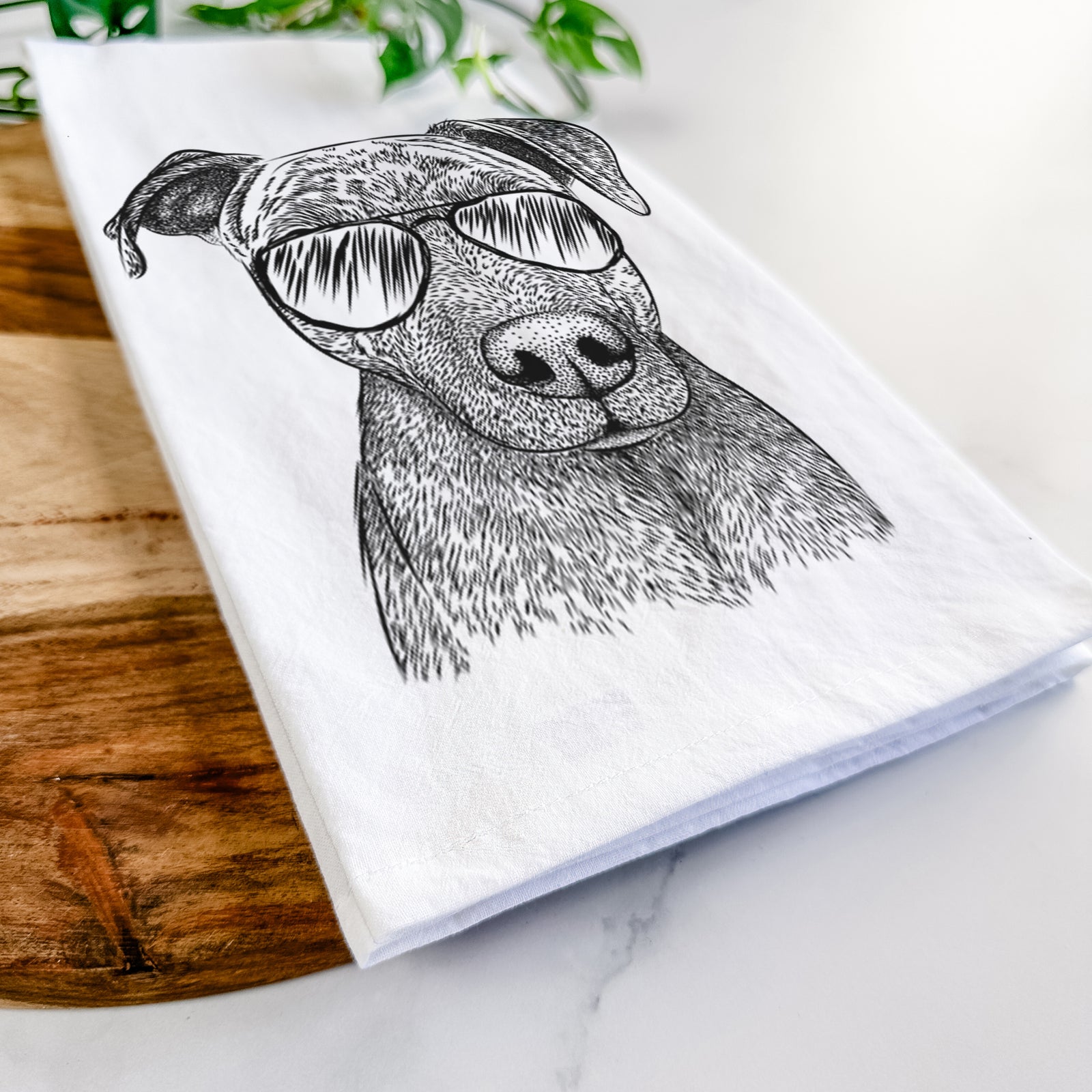 Hand-drawn sketch of Reeses the Pitbull wearing aviator sunglasses on a tea towel