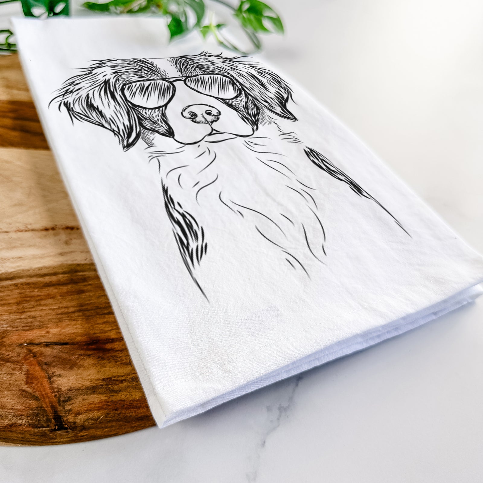 Hand-drawn sketch of Remi the Brittany wearing aviator sunglasses on a tea towel