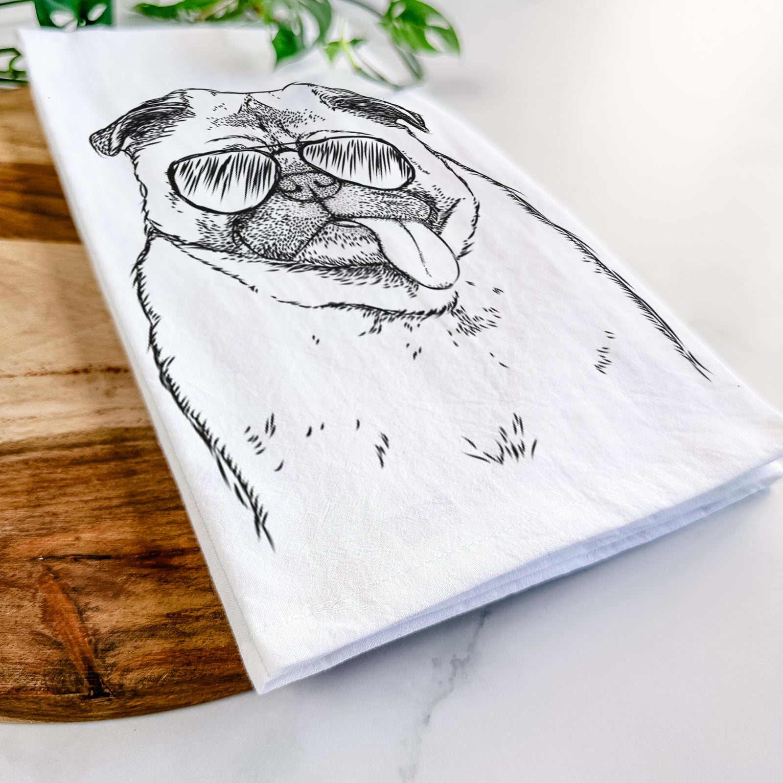 Hand-drawn sketch of Rosie the Pug wearing aviator sunglasses on a tea towel