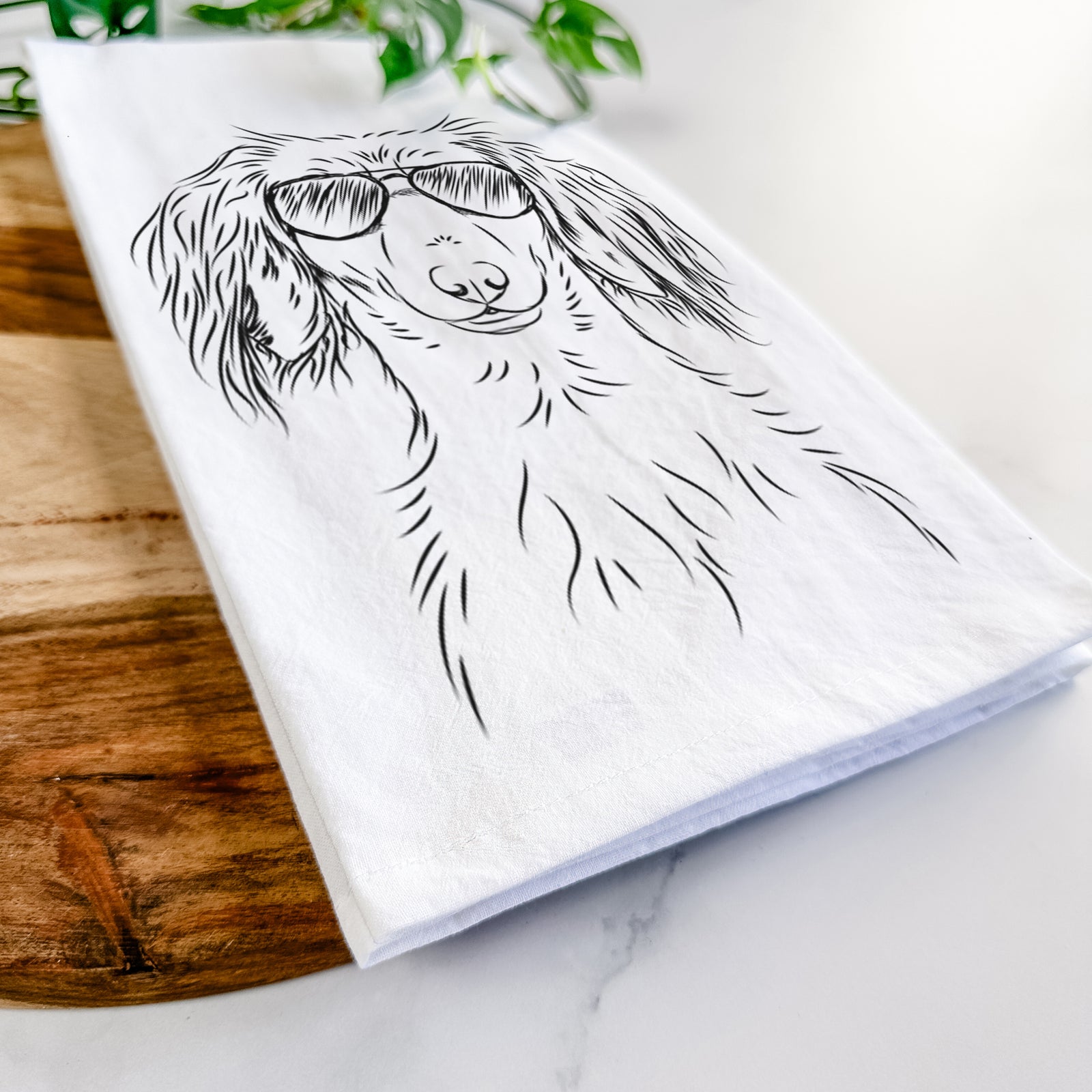 Hand-drawn sketch of Roux the Long Haired Dachshund wearing aviator sunglasses on a tea towel