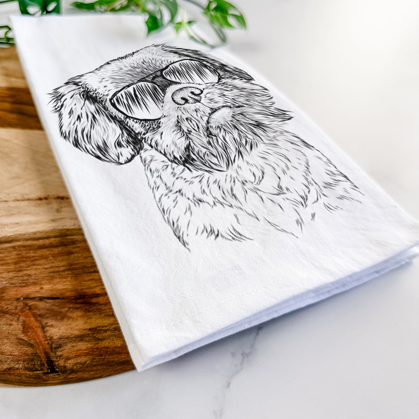 Hand-drawn sketch of Rufus the Shiffon wearing aviator sunglasses on a tea towel