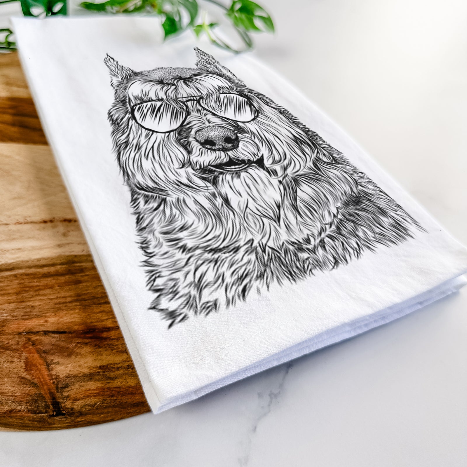 Hand-drawn sketch of Sabre the Bouvier Des Flandres wearing aviator sunglasses on a tea towel