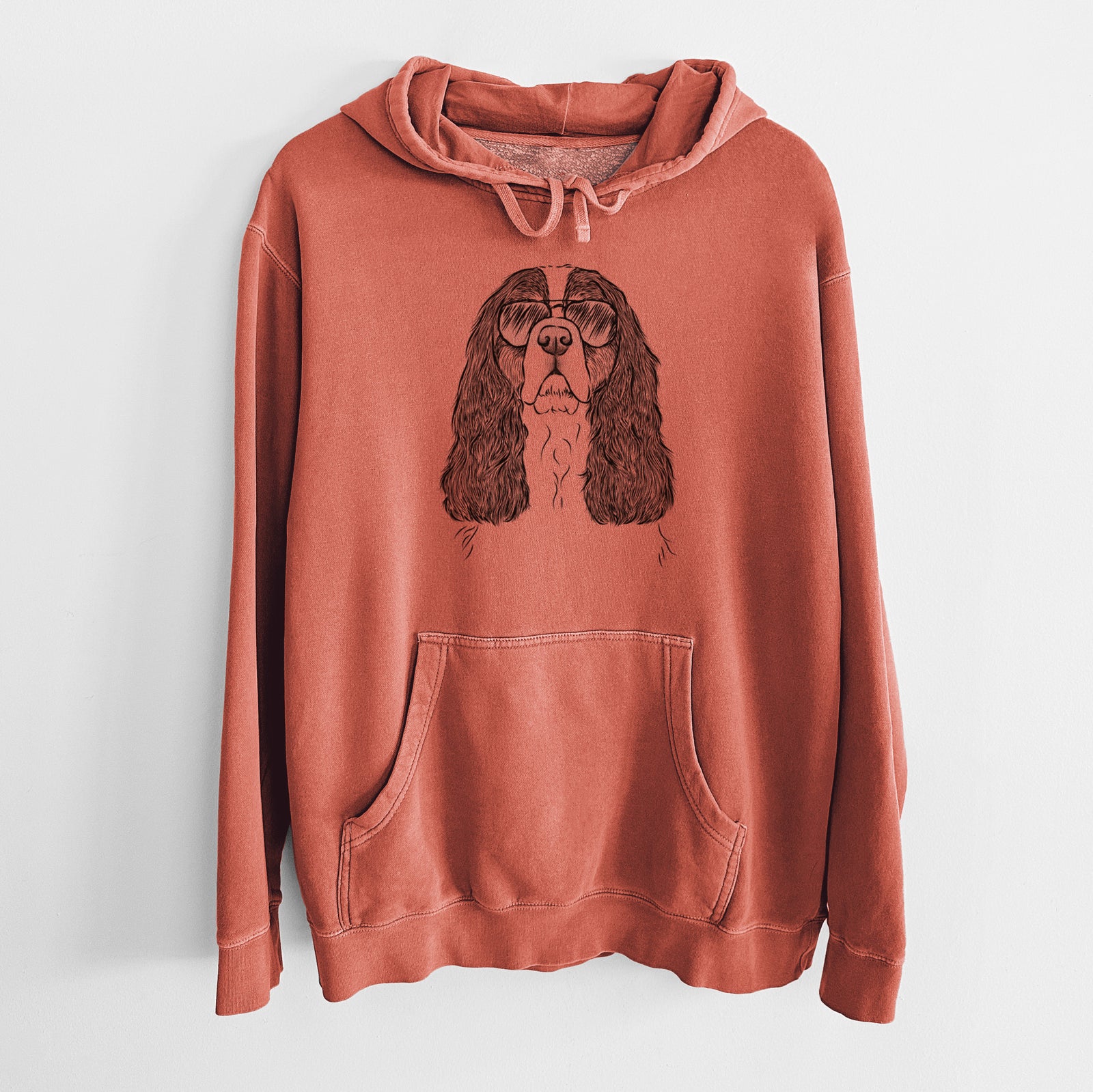 Hand-drawn sketch of Sebastian the Cavalier King Charles Spaniel wearing aviator sunglasses on an Amber Unisex pigment dyed hoodie