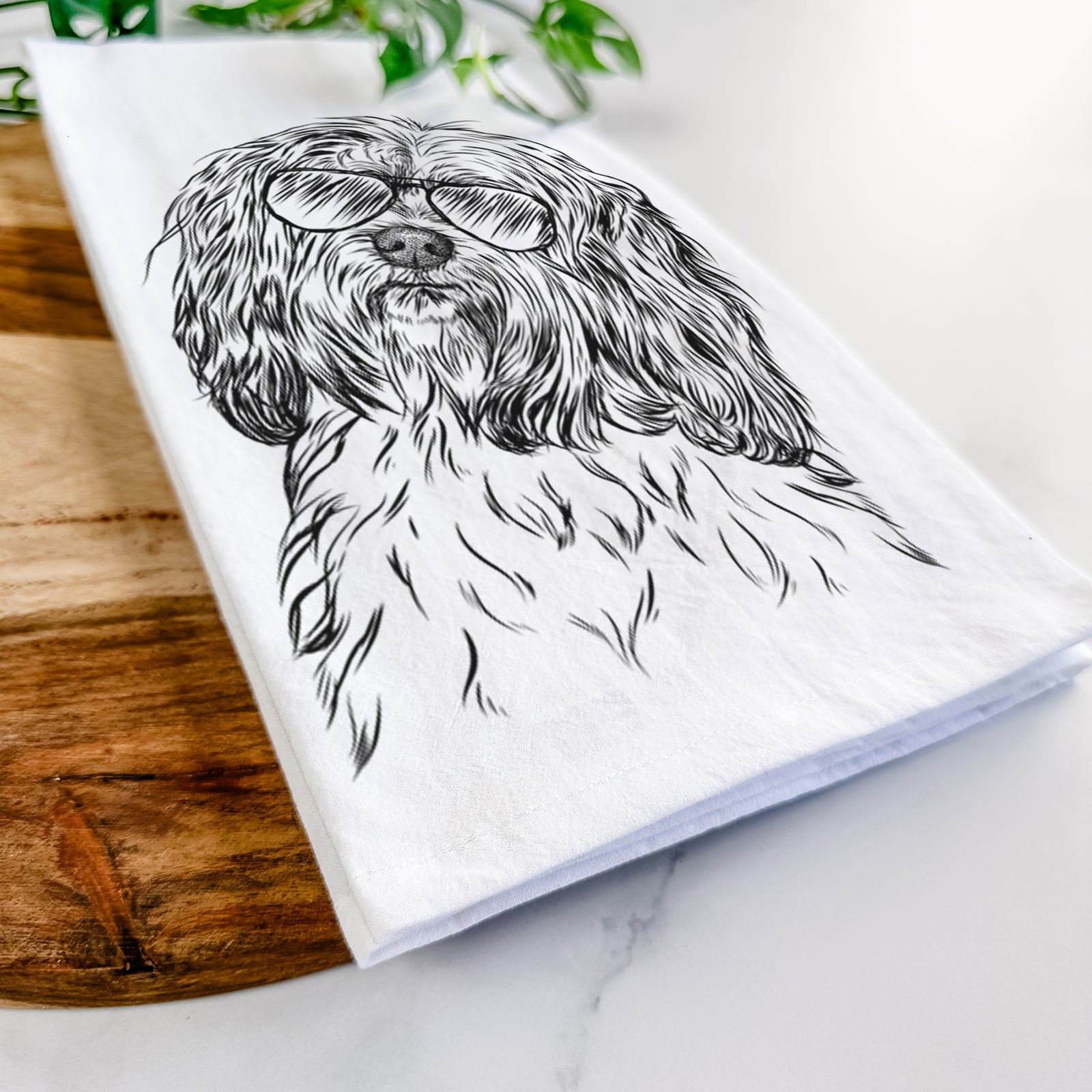 Hand-drawn sketch of Shenpa the Tibetan Terrier wearing aviator sunglasses on a tea towel