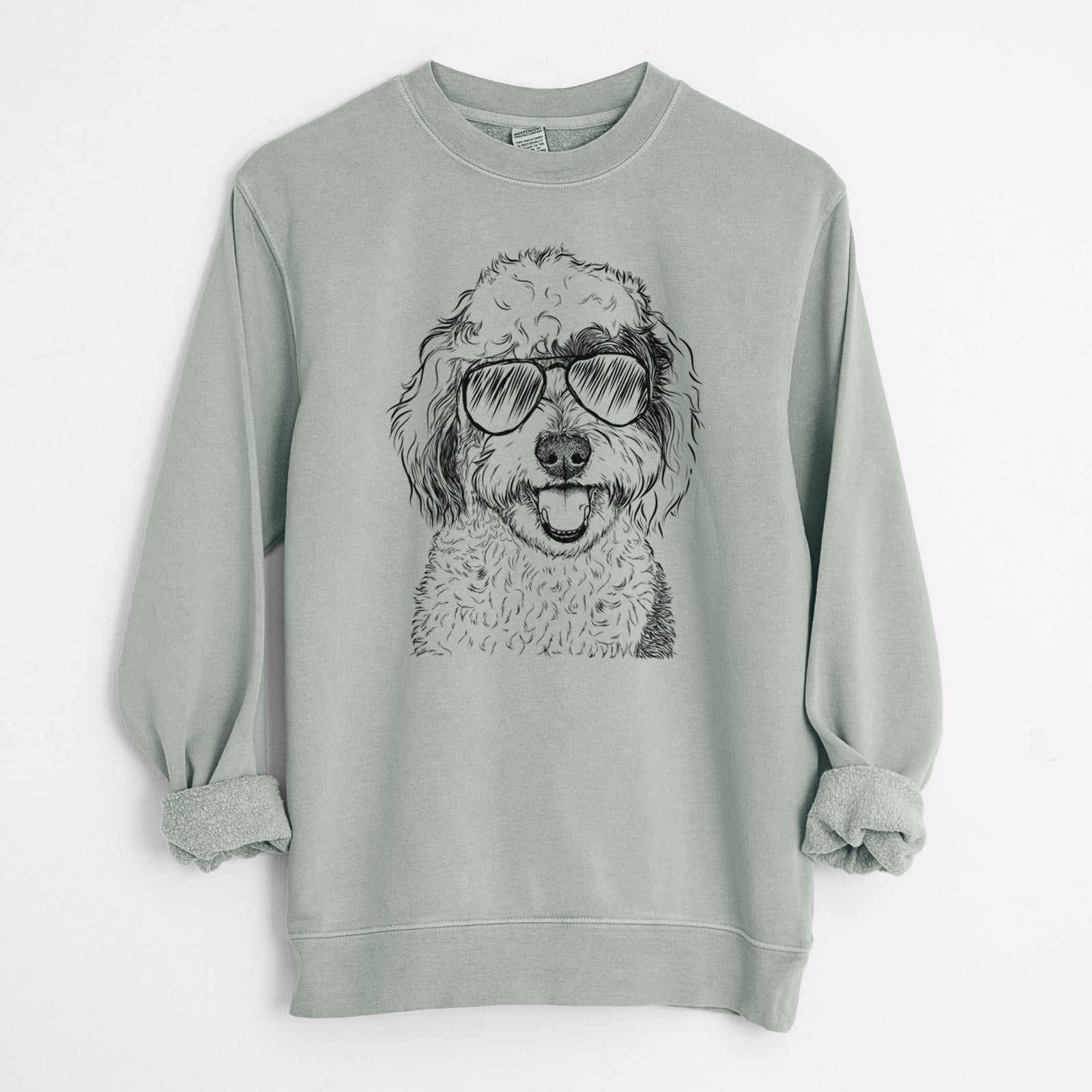 Hand-drawn sketch of Sherlock the Sheepadoodle wearing aviator sunglasses on a Sage Unisex pigment dyed crew sweatshirt