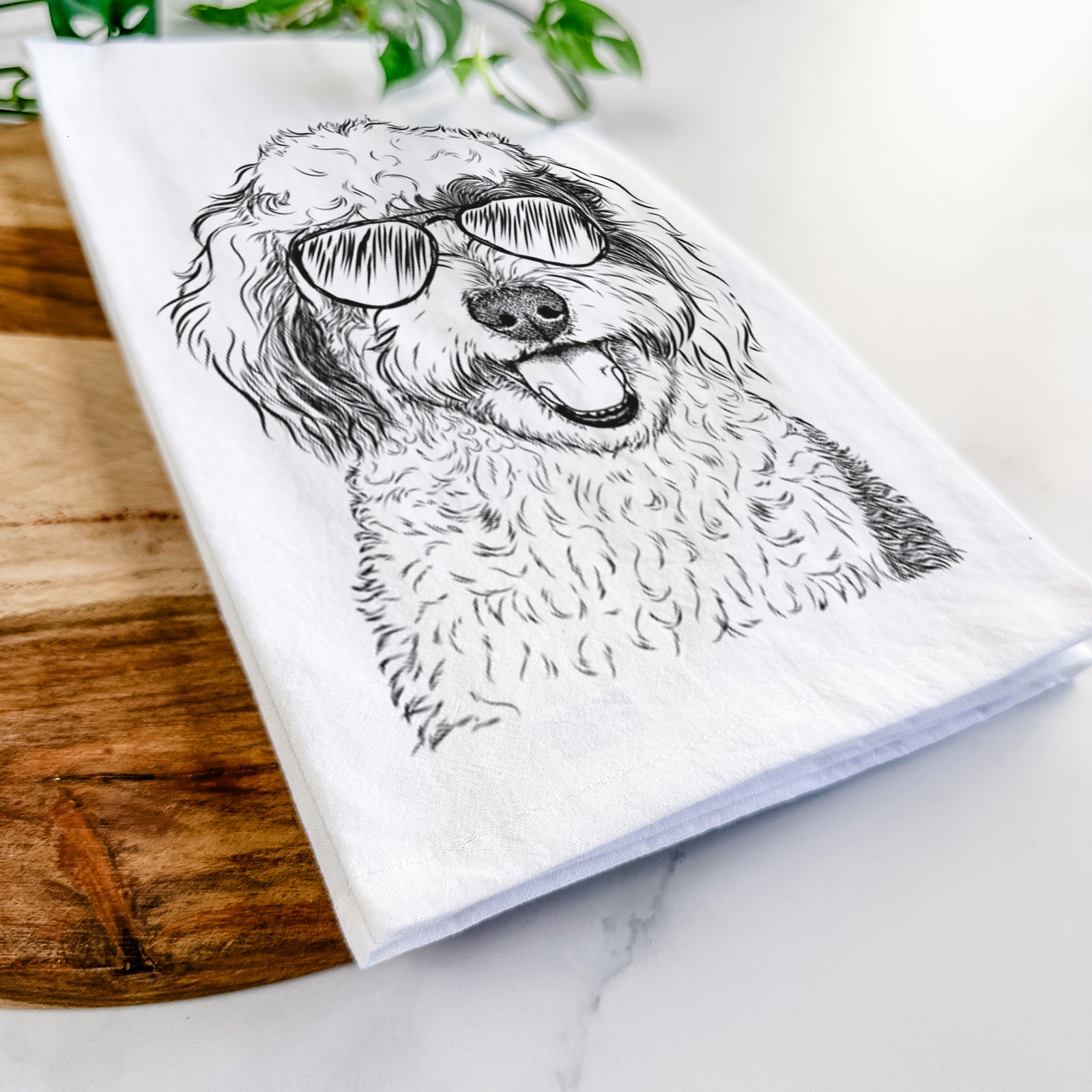 Hand-drawn sketch of Sherlock the Sheepadoodle wearing aviator sunglasses on a tea towel