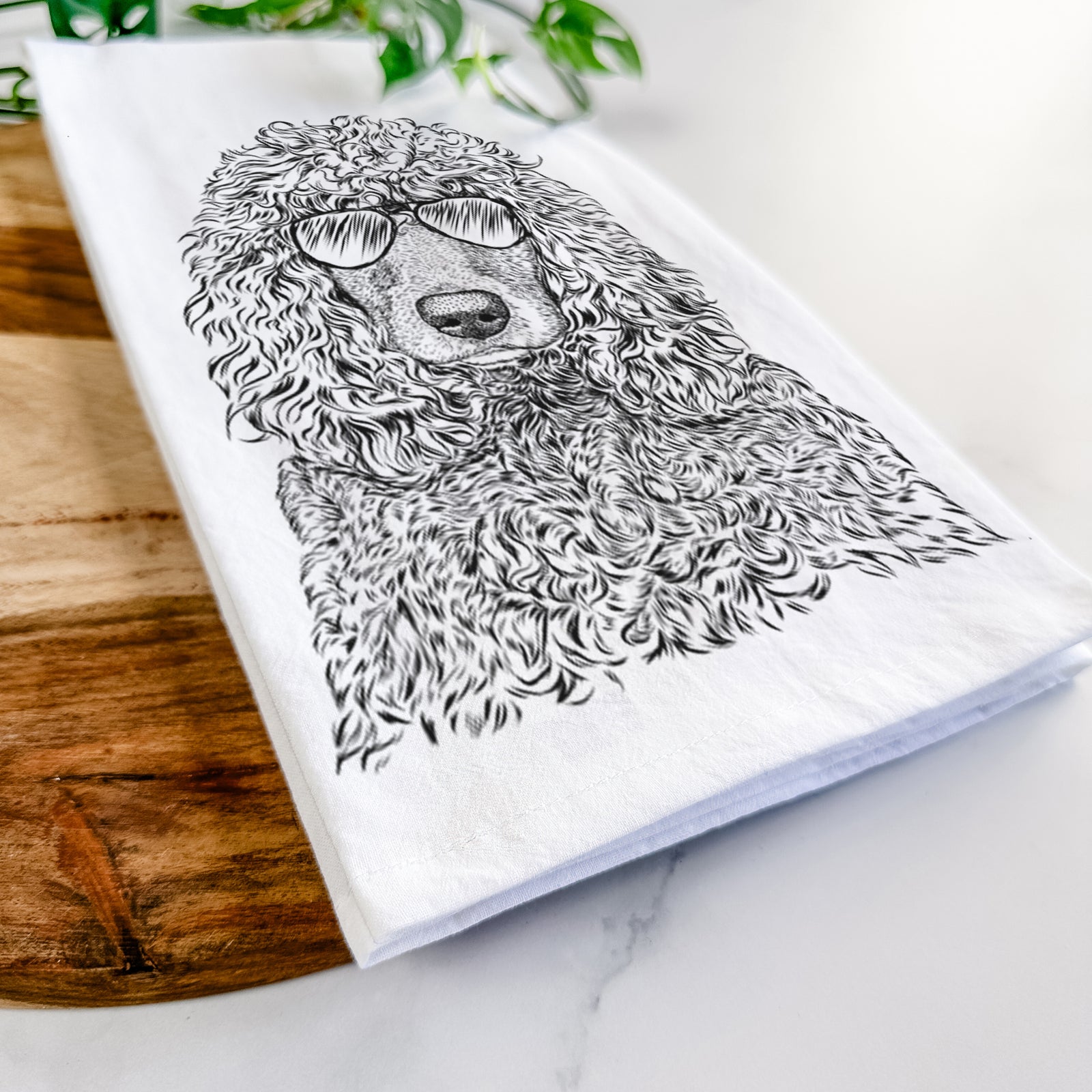Hand-drawn sketch of Shilo the Irish Water Spaniel wearing aviator sunglasses on a tea towel
