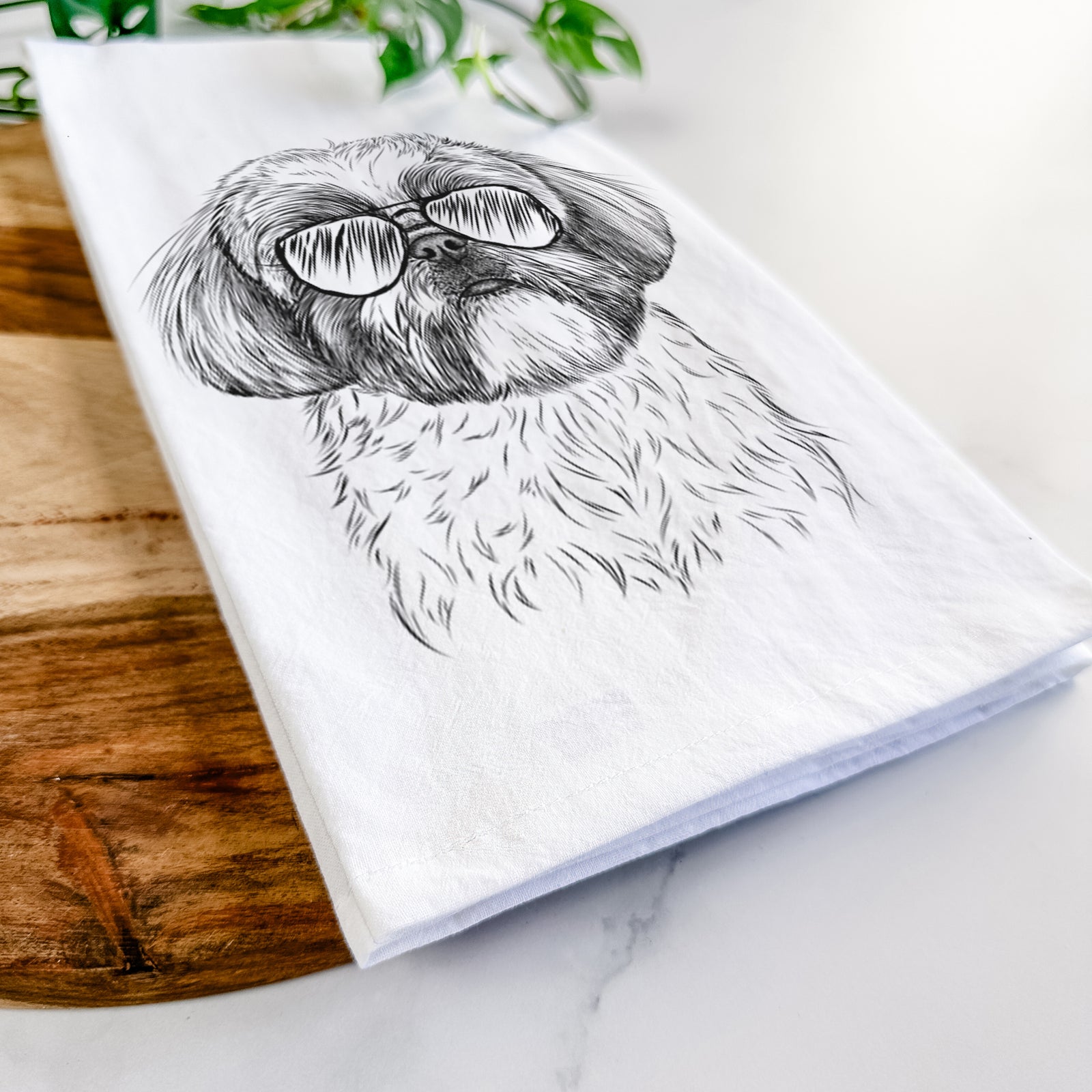 Hand-drawn sketch of Simon the Shih Tzu wearing aviator sunglasses on a tea towel