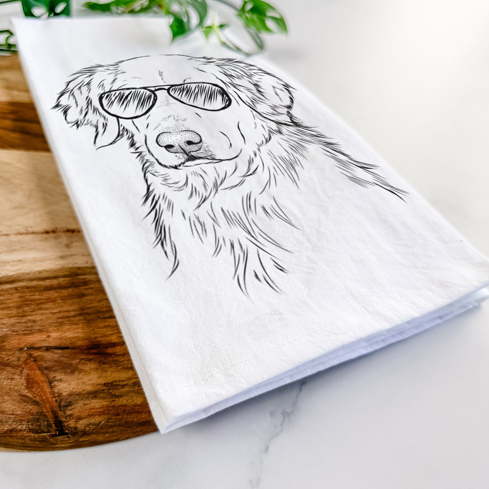 Hand-drawn sketch of Spencer the Golden Retriever wearing aviator sunglasses on a tea towel