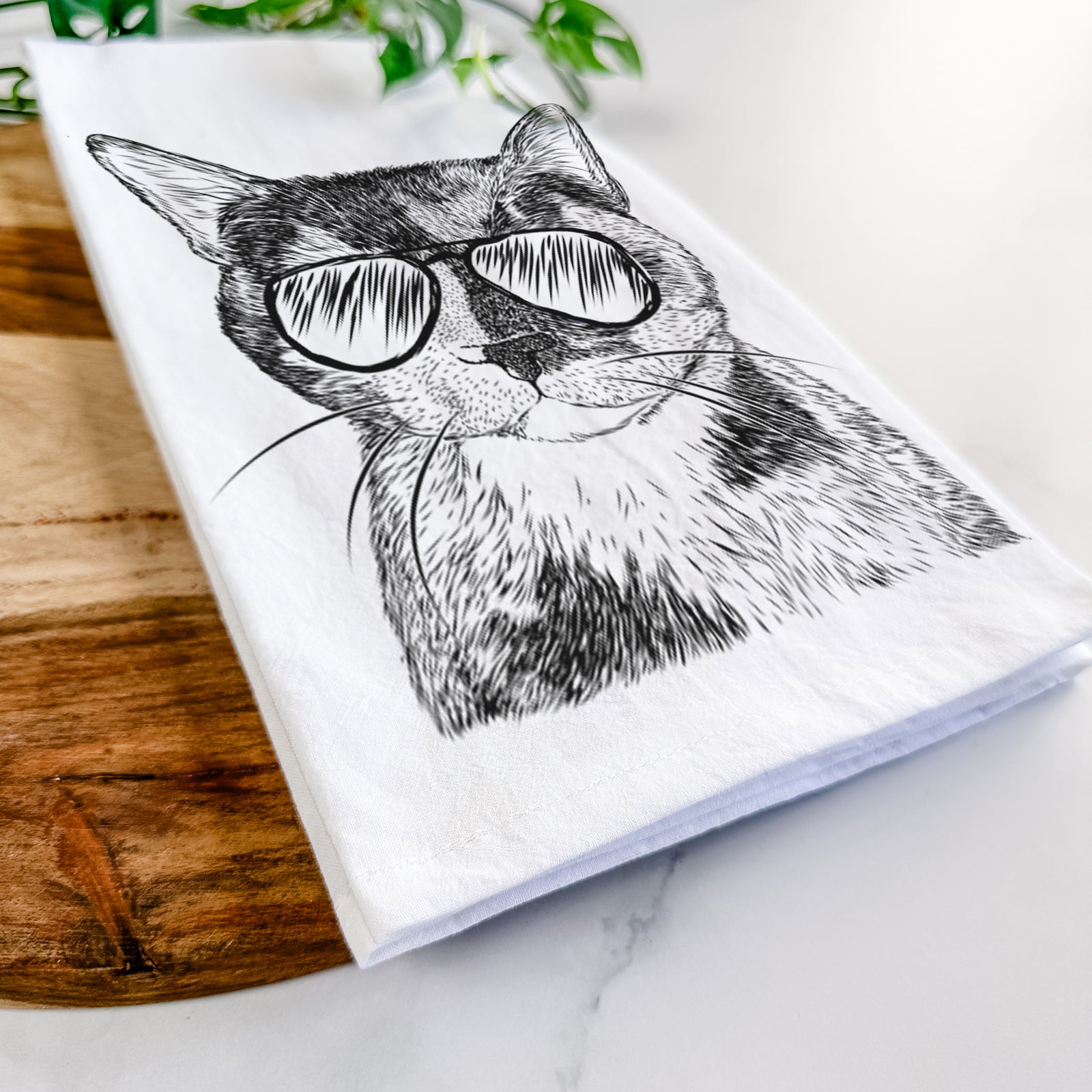Hand-drawn sketch of Spooky Kitty the Tortoiseshell Cat wearing aviator sunglasses on a tea towel