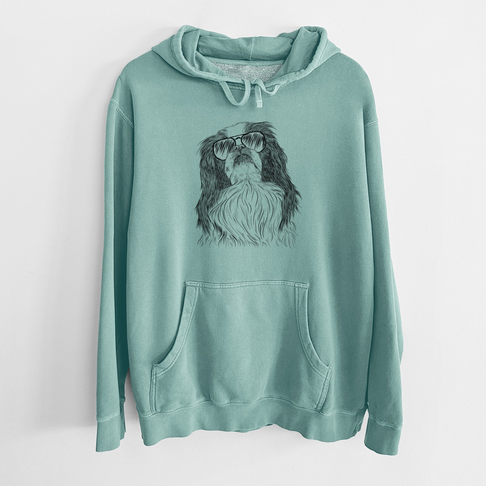Hand-drawn sketch of Suki the Japanese Chin wearing aviator sunglasses on a Mint Unisex pigment dyed hoodie