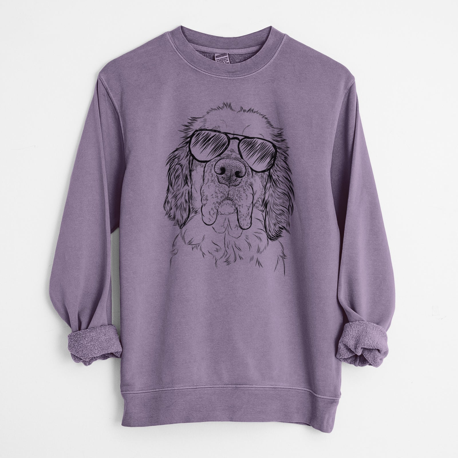 Hand-drawn sketch of Sully the Clumber Spaniel wearing aviator sunglasses on a Plum Unisex pigment dyed crew sweatshirt