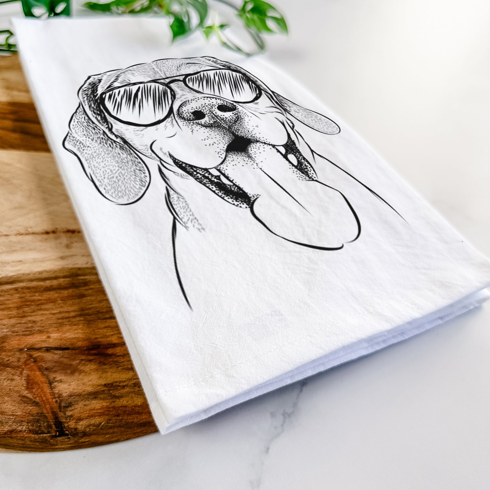 Hand-drawn sketch of Sunny the Beagle wearing aviator sunglasses on a tea towel